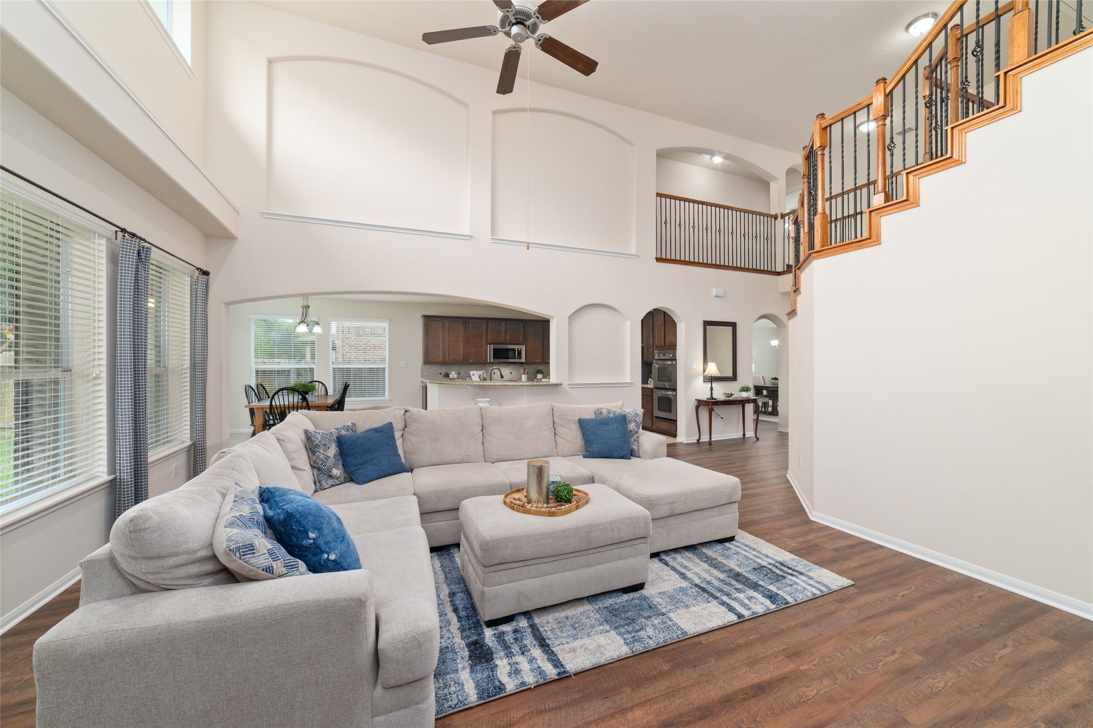 Vaulted ceilings, arched walkways and art niches add elegant architectural detail to the bright open living room at the heart of the home.