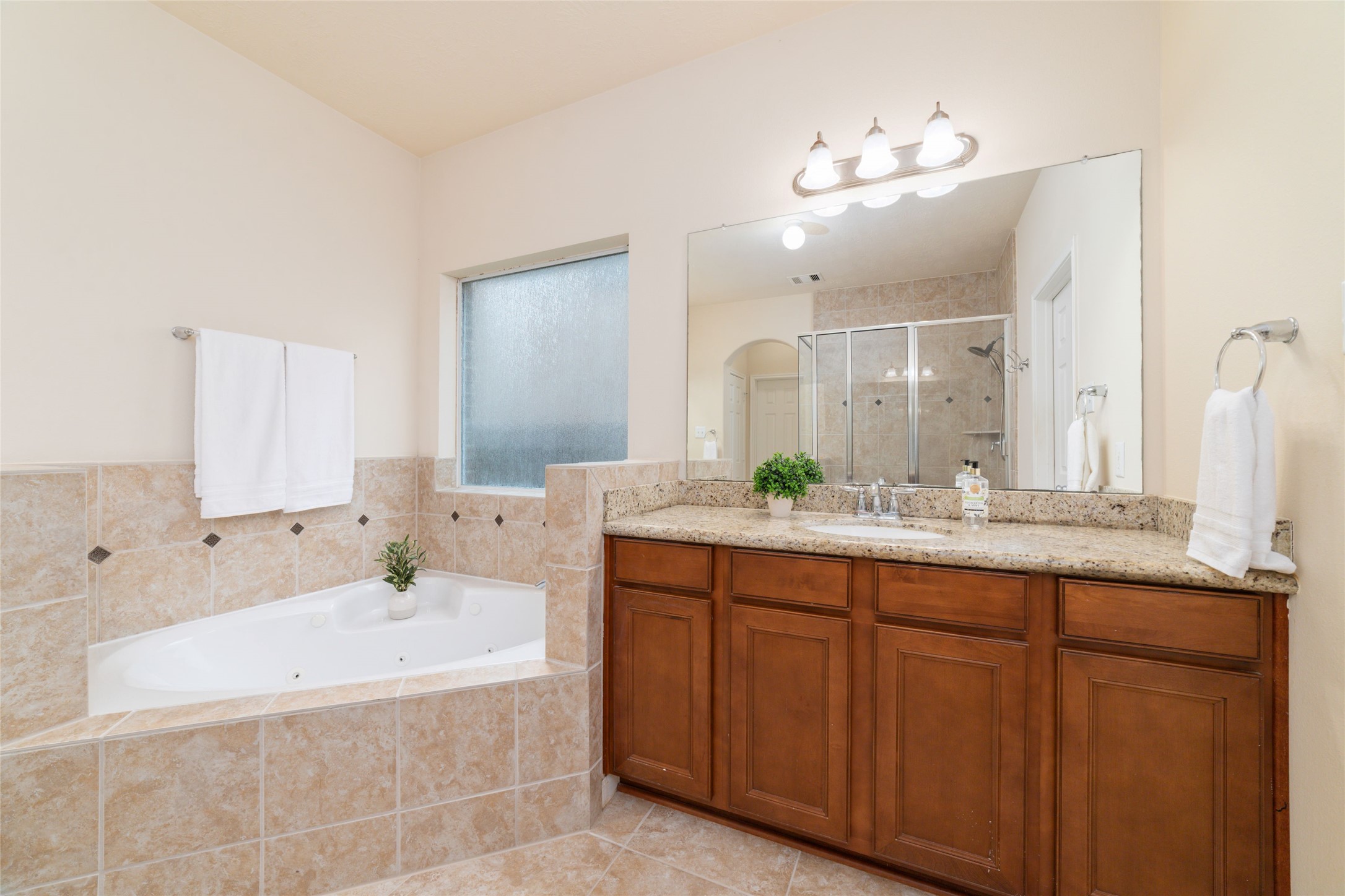 The spa-like bathroom also features a separate soaking/jetted tub.