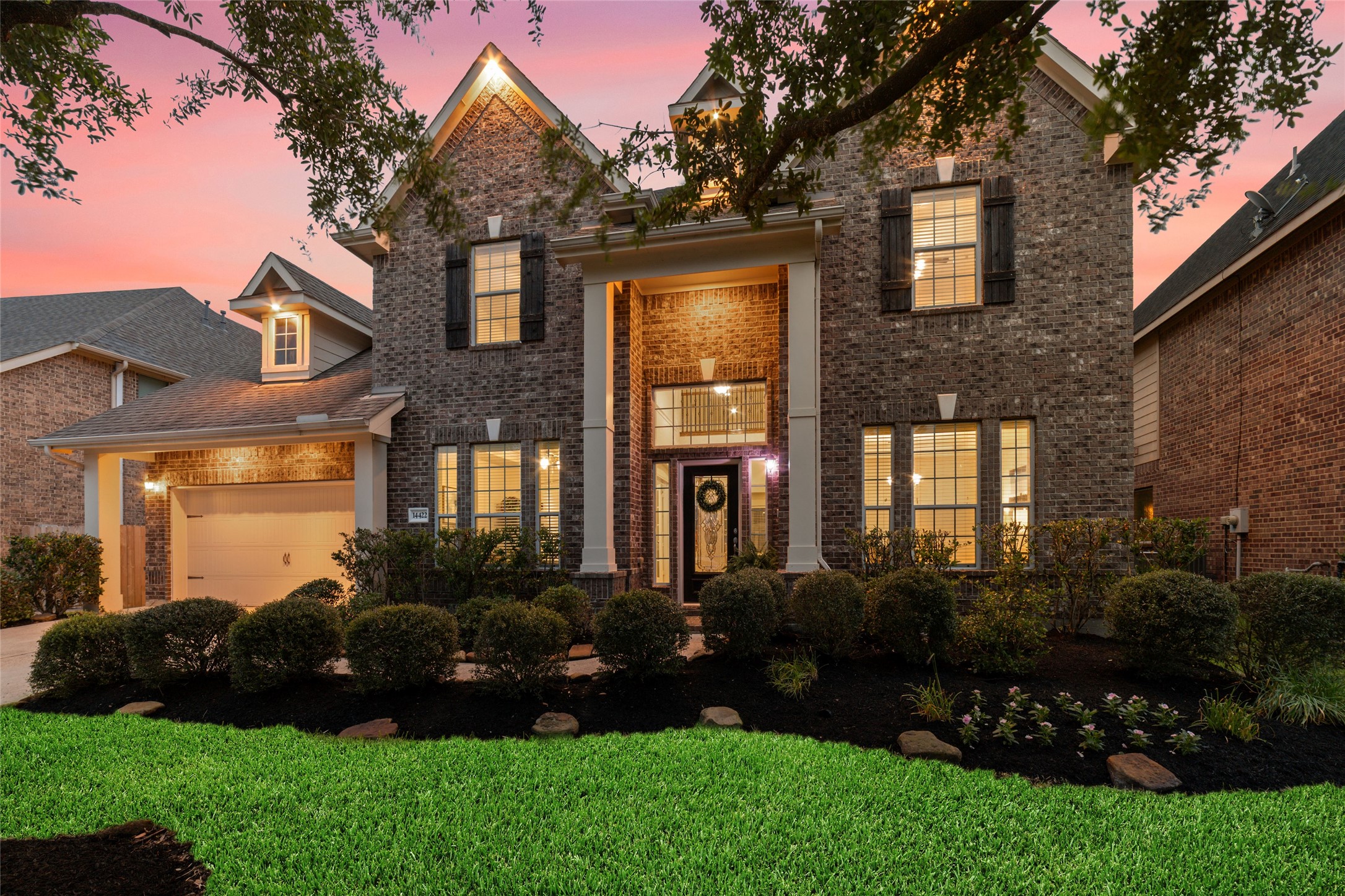 Mature trees, beautiful established landscaping and added outdoor, low voltage, app controlled lighting create a picturesque front view.