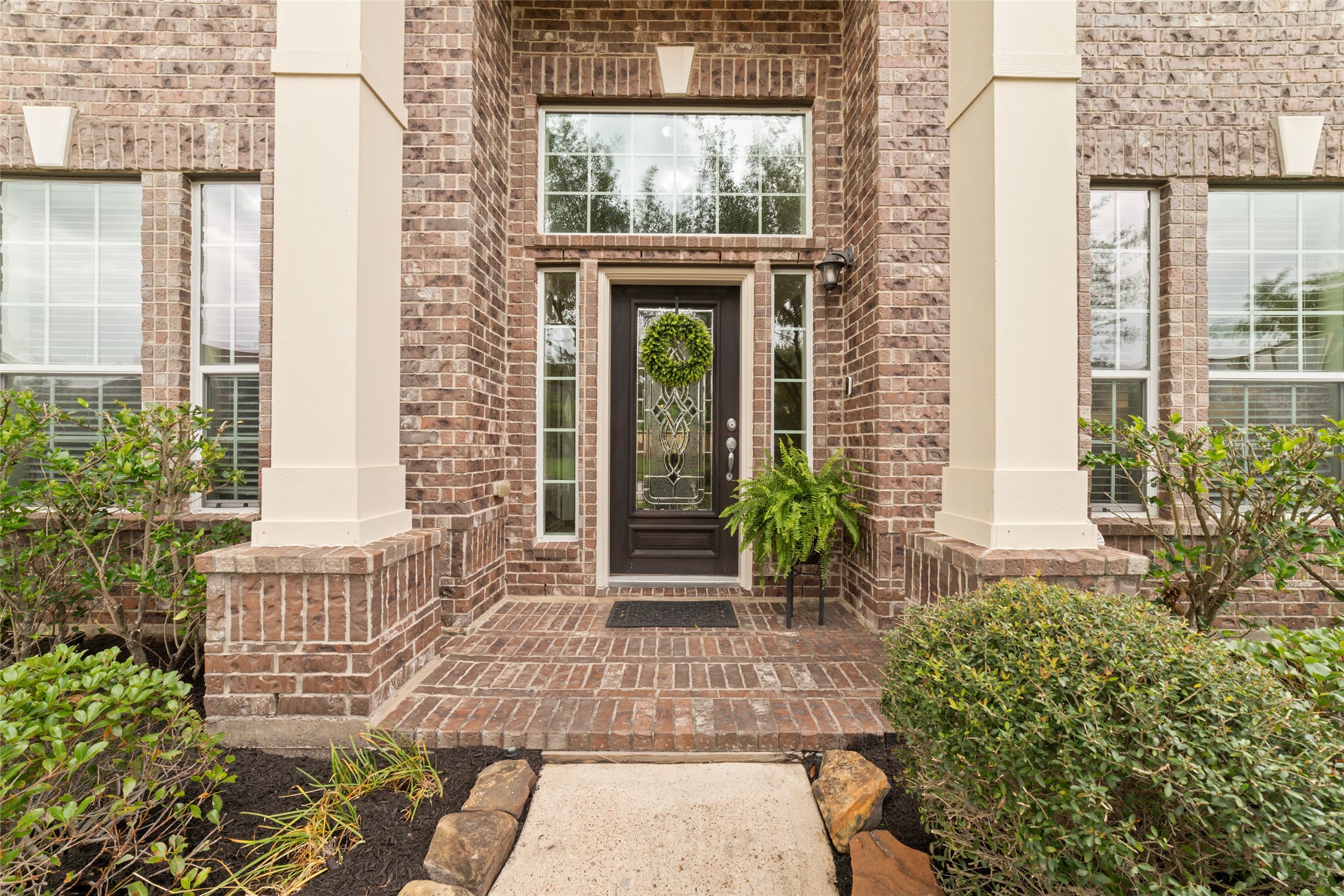 Elegant entry framed by soaring ceilings and natural light