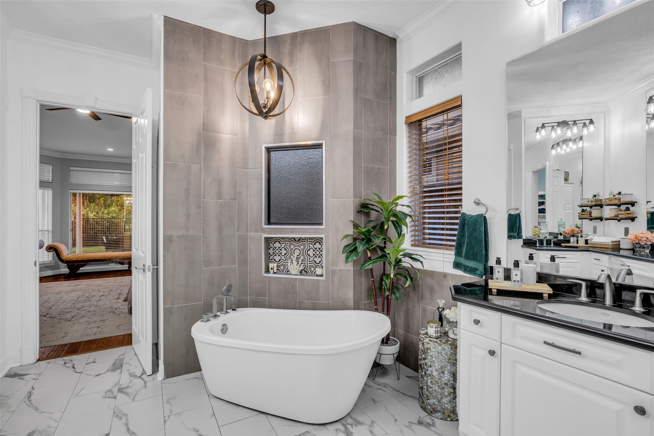 The bathroom has been updated with a soaking tub and new tile in the walk-in shower located behind the tub.