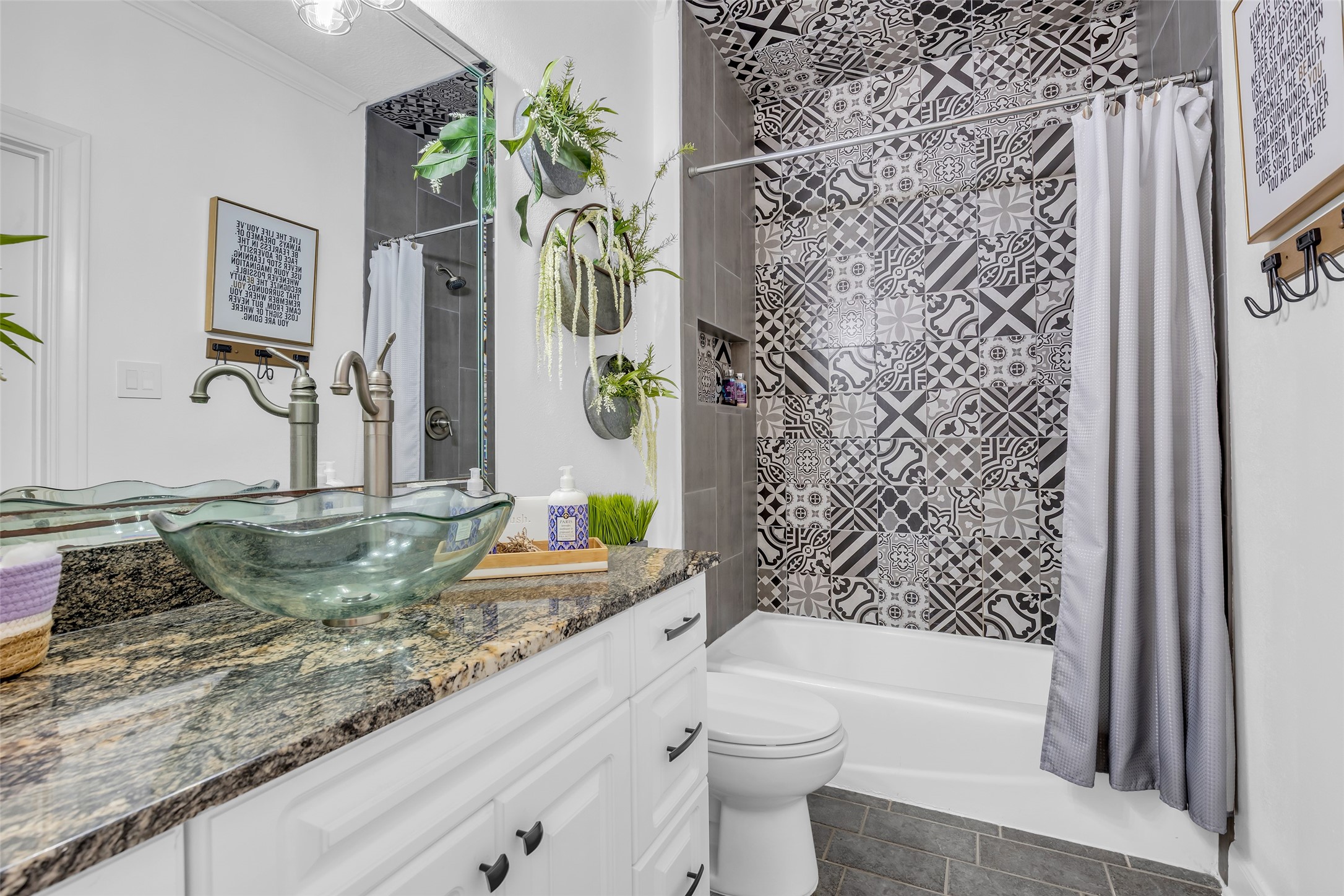 The en-suite bathroom with updated tile to the ceiling.