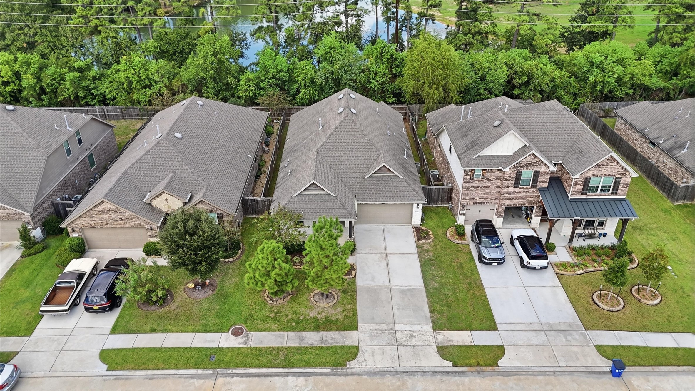 Beautiful single-story home featuring a stone-and-brick exterior, welcoming covered entry, manicured landscaping, and a two-car garage.