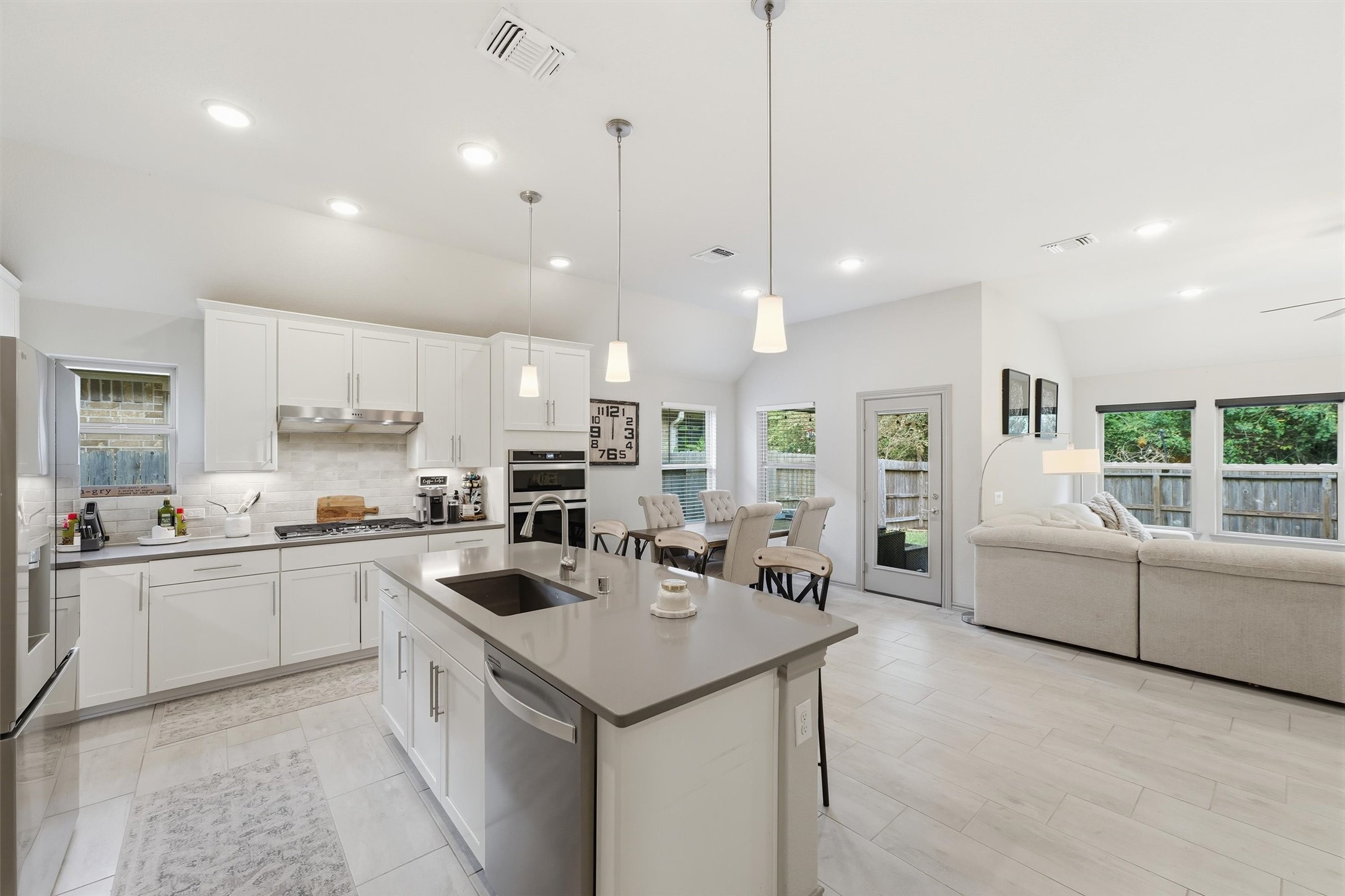 Expansive open-concept layout connecting the kitchen, dining, and living areas, perfect for everyday living and entertaining.