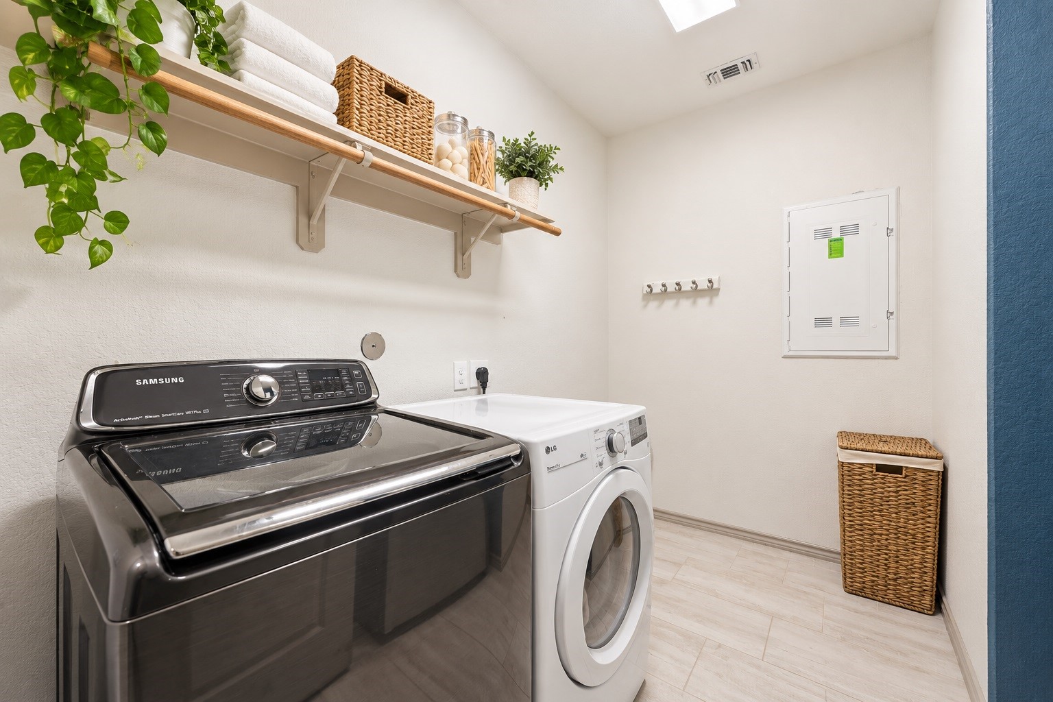 Virtually staged  Towels, baskets, plants, and a hamper were digitally added.