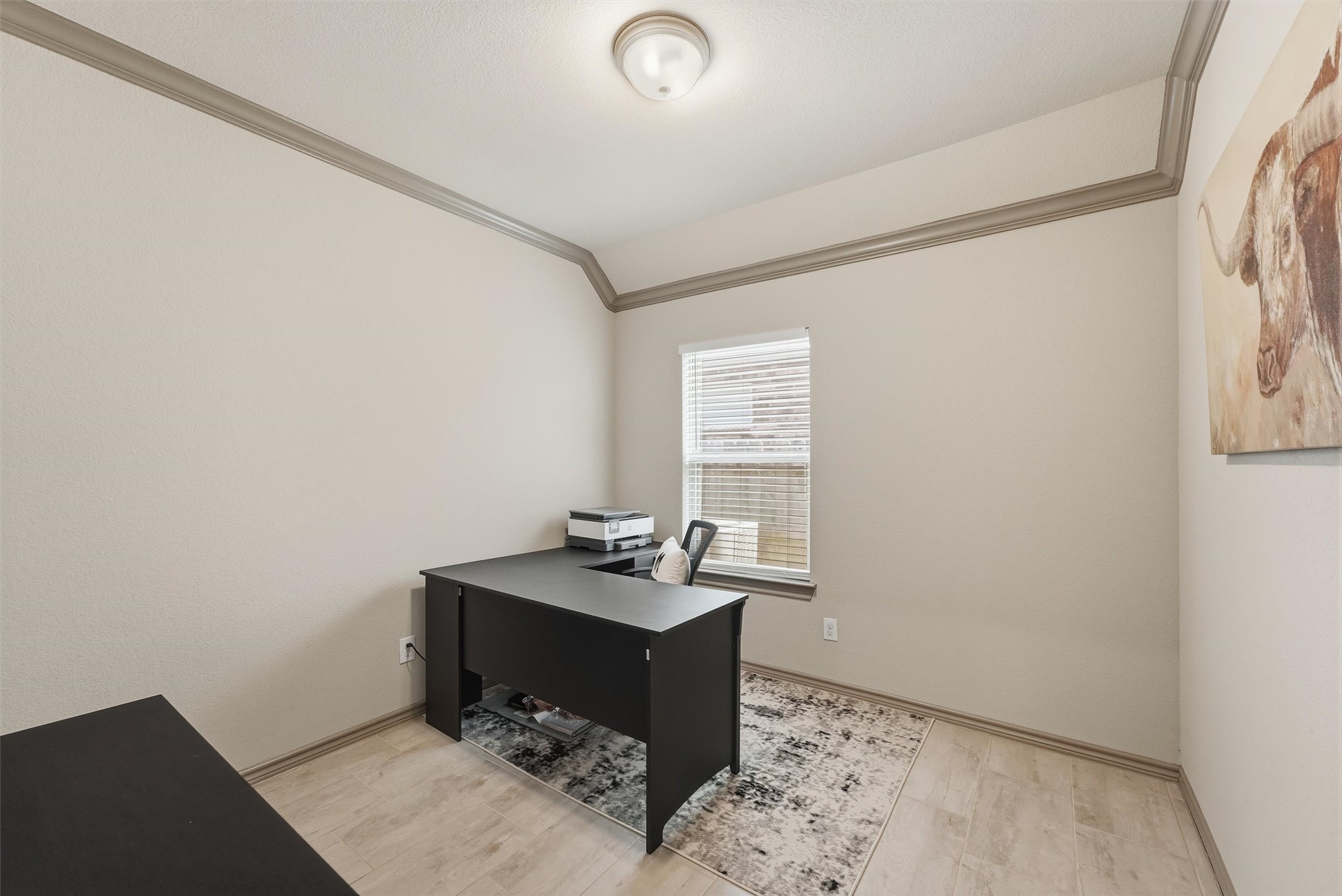 Private home office with an executive-style desk, natural light, and a neutral color palette, ideal for working from home.