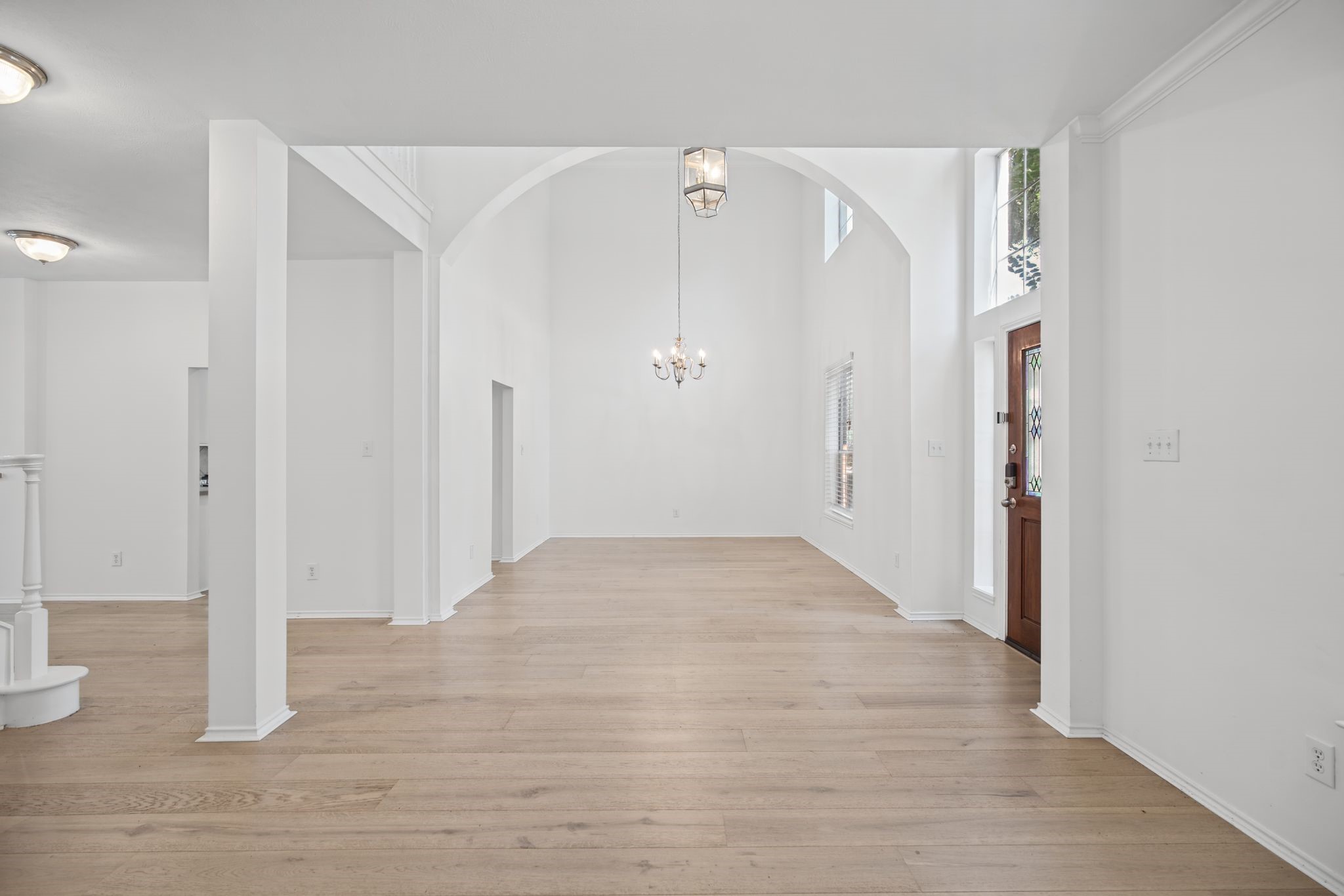 The entry introduces an inviting arrangement of the formal living and dining spaces, connected by a sweeping arched opening. The entry introduces an inviting arrangement of the formal living and dining spaces, connected by a sweeping arched opening.