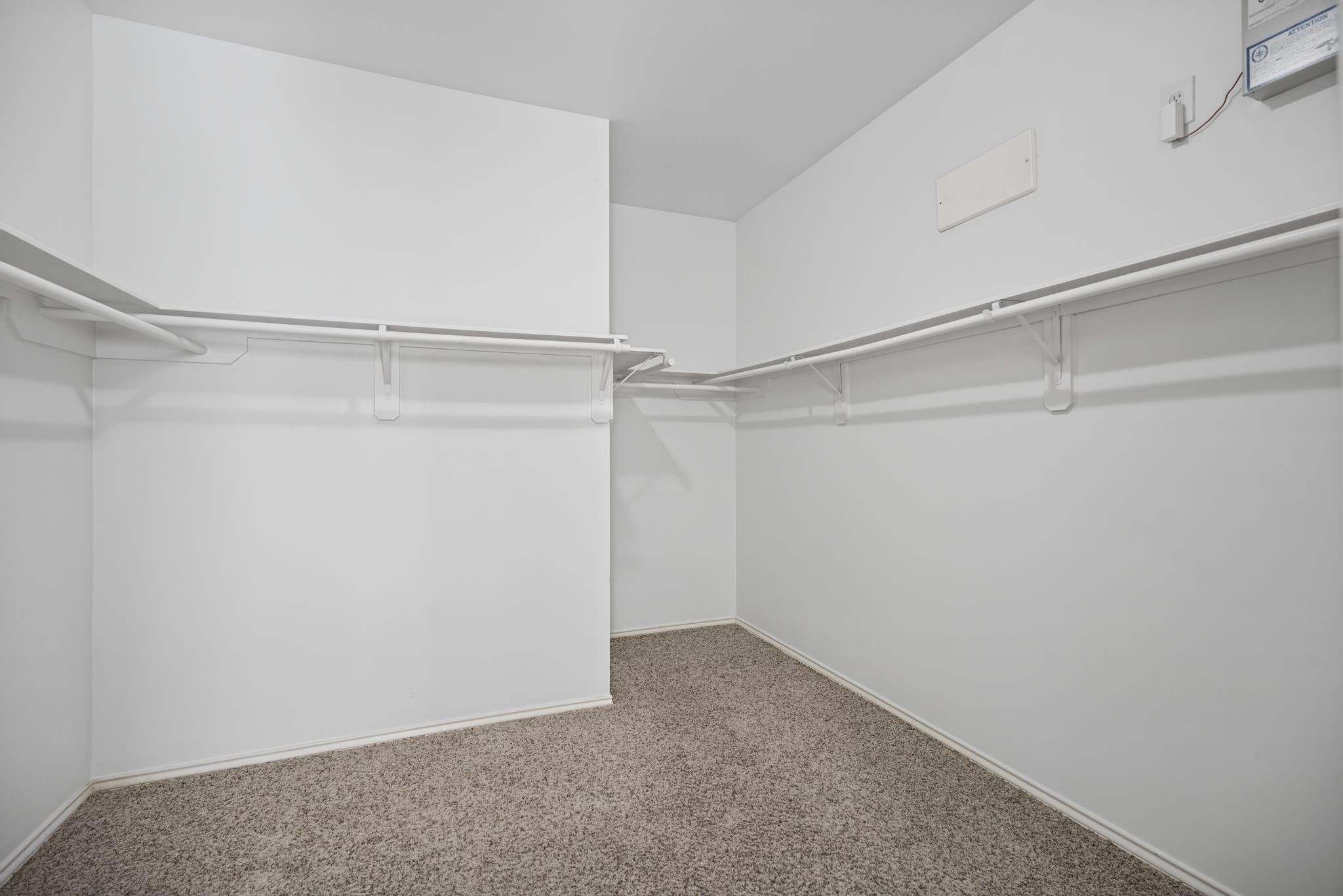 The walk-in closet completes this portion of the suite with shelving and hanging space arranged along multiple walls.