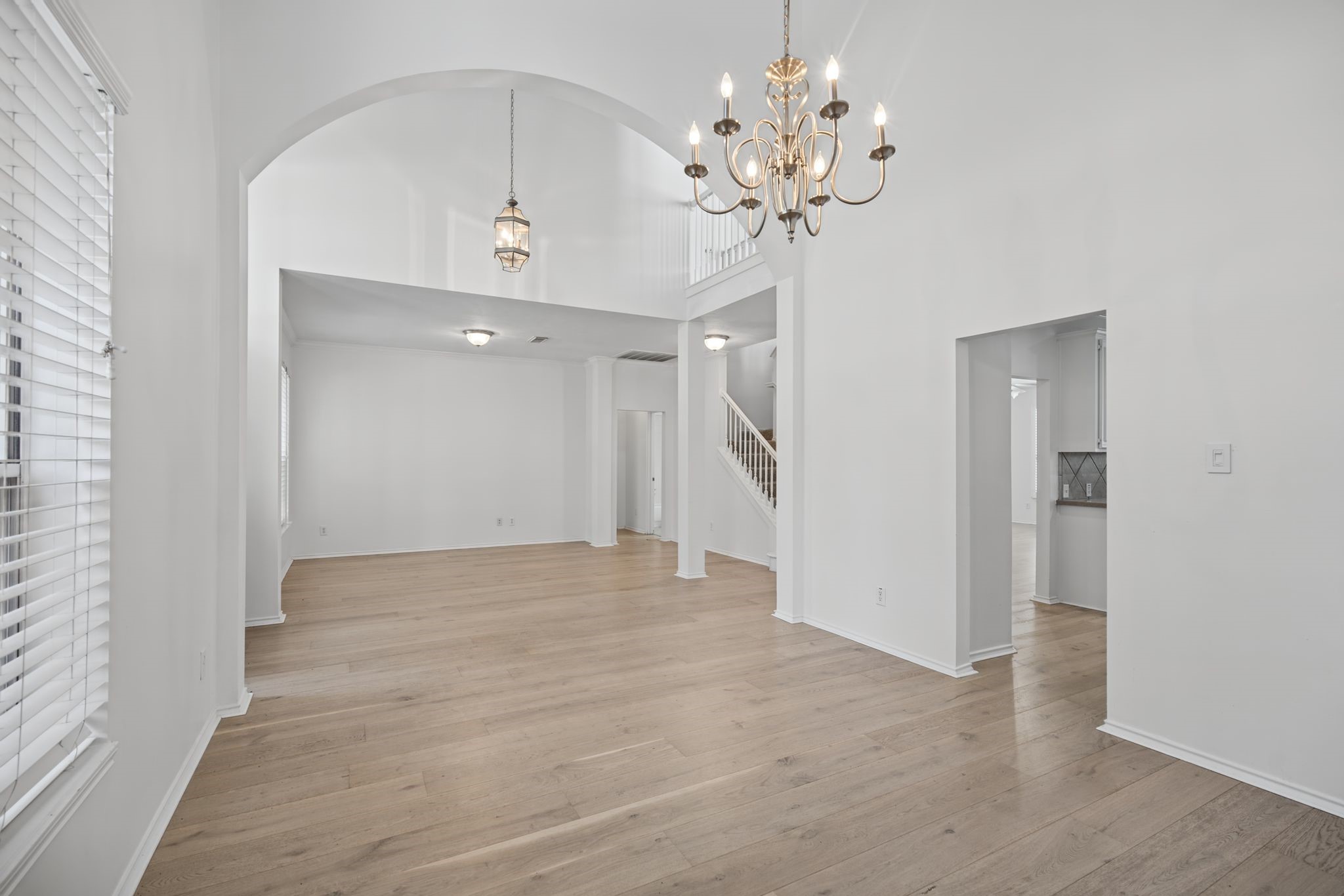 Continue into the dining room, where a chandelier and broad archway lend definition and a sense of occasion to the space.
