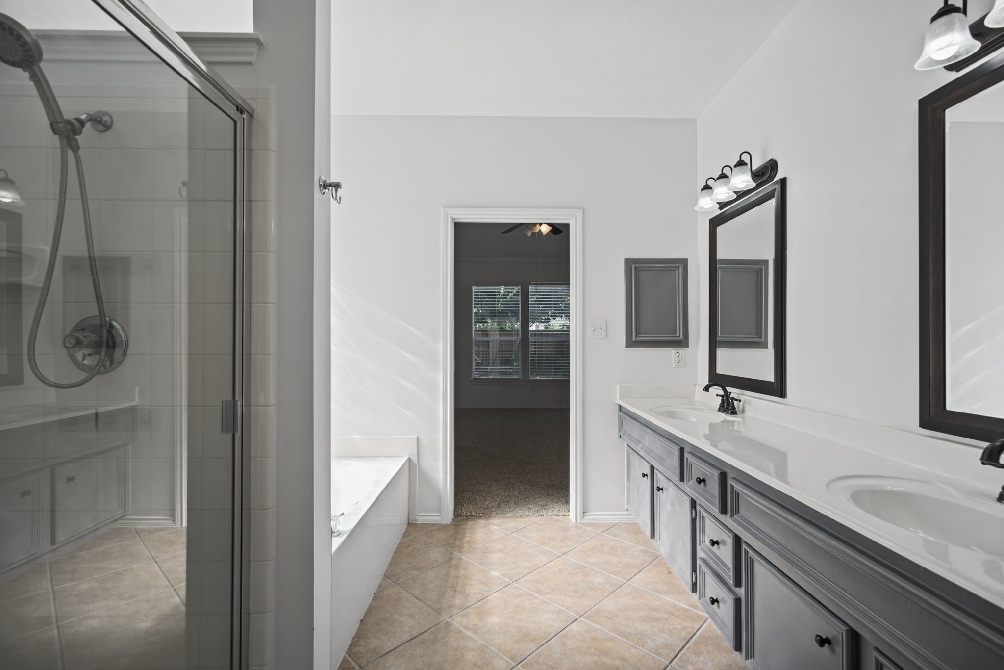 Another perspective reveals the separate bathtub and glass-enclosed shower.