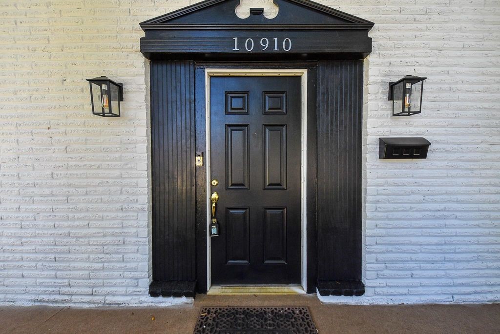 Sleek entry door with lanterns