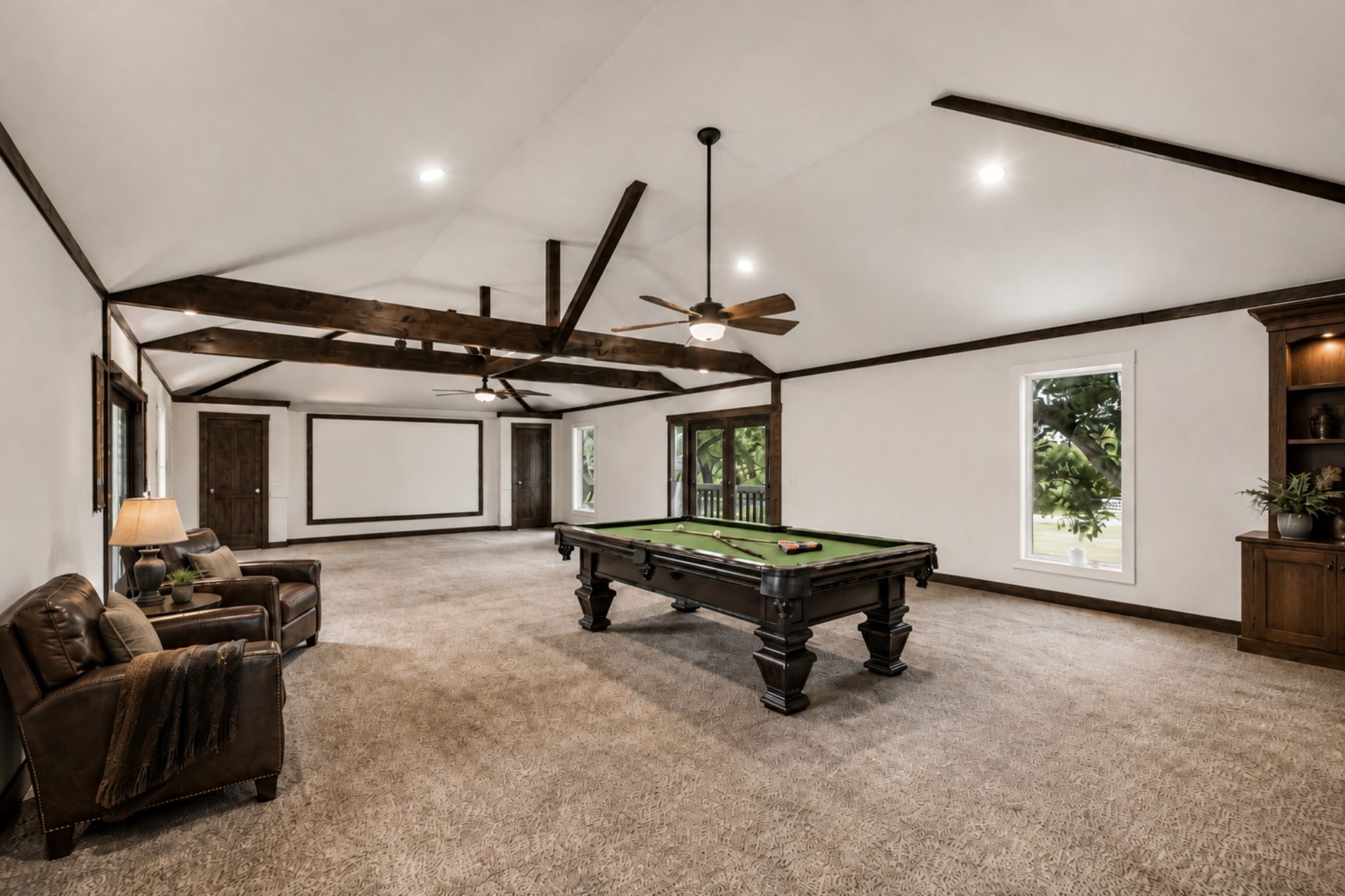 EXPANSIVE GAME ROOM SHOWCASES EXPOSED WOOD BEAMS, A VAULTED CEILING, RECESSED LIGHTING, MULTIPLE WINDOWS, AND GENEROUS OPEN FLOOR SPACE. ***Virtually Staged.