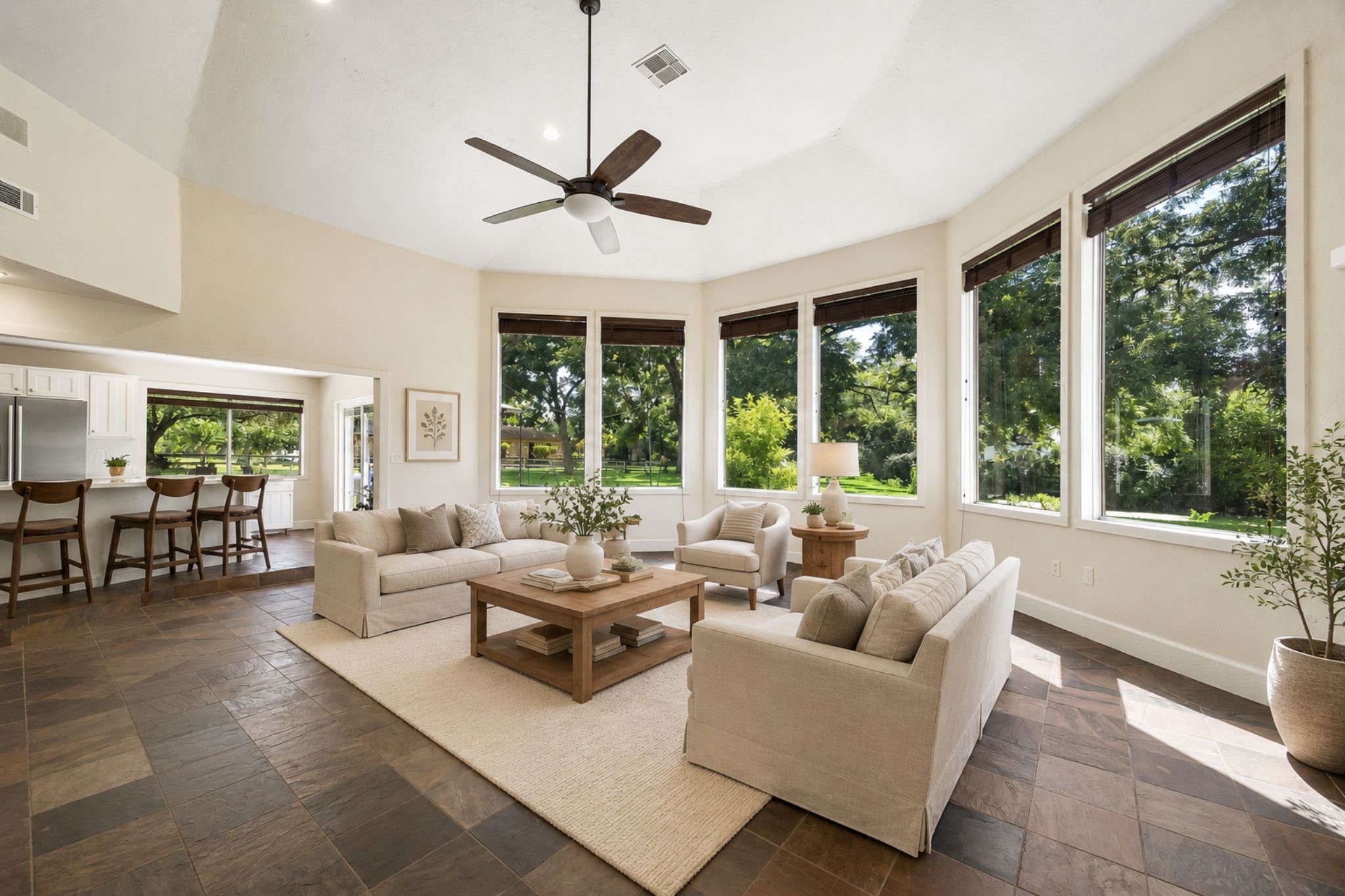 MULTIPLE OVERSIZED WINDOWS, HIGH CEILING, AND TILE FLOORING CREATE A BRIGHT, OPEN LIVING SPACE WITH VIEWS OF THE GROUNDS. ***Virtually Staged.
