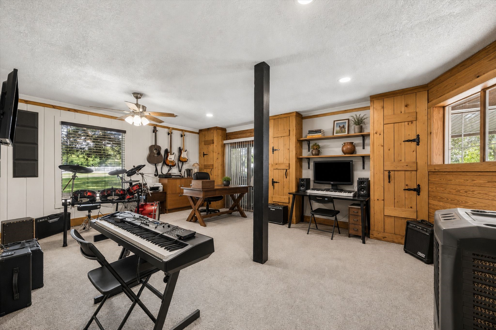 LARGE FLEX SPACE FEATURES CARPET FLOORING, BUILT-IN WOOD CABINETRY, MULTIPLE WINDOWS, AND AMPLE ROOM FOR A VARIETY OF USES.