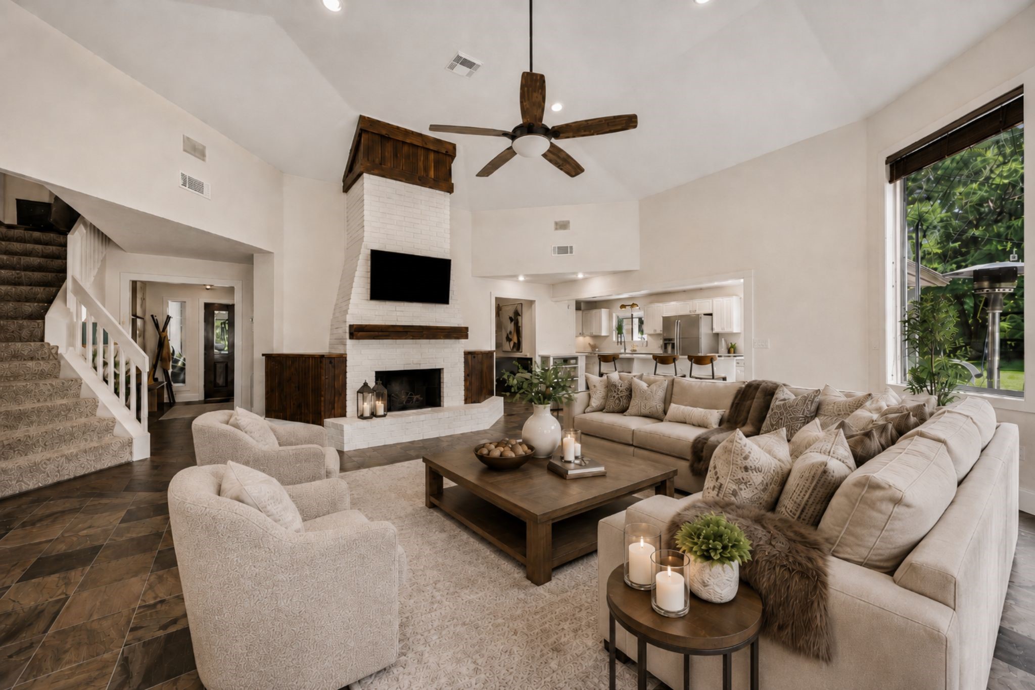 SPACIOUS MAIN LIVING AREA FEATURES A VAULTED CEILING, FIREPLACE, TILE FLOORING, AND OPEN SIGHTLINES INTO THE KITCHEN. ***Virtually Staged.