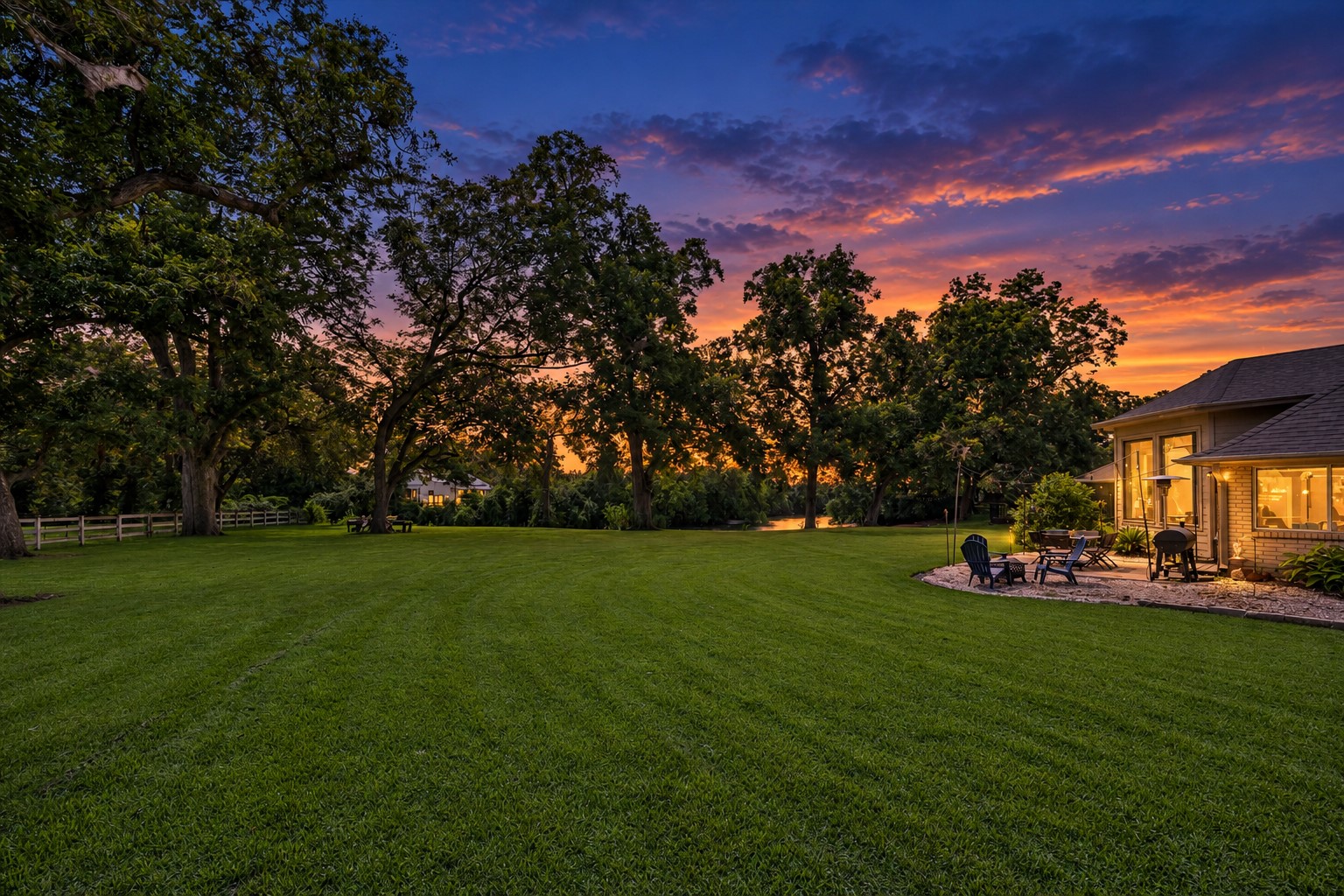 LARGE BACKYARD WITH DIRECT CREEK ACCESS - PROVIDES WIDE OPEN LAWN SPACE, MATURE SHADE TREES, AND A PATIO AREA ADJACENT TO THE HOME.