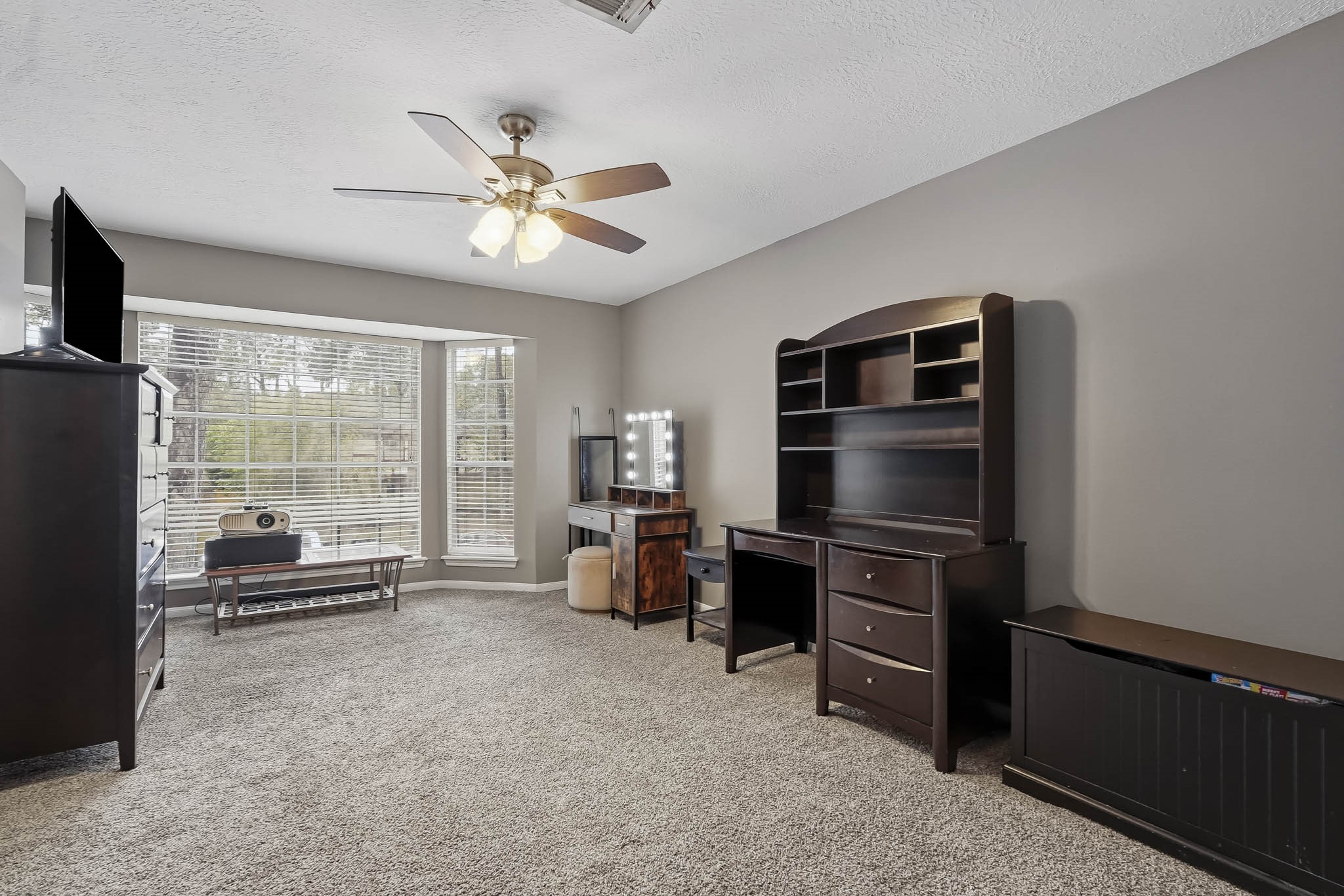Bright and spacious room with large windows, neutral tones, and ample space.