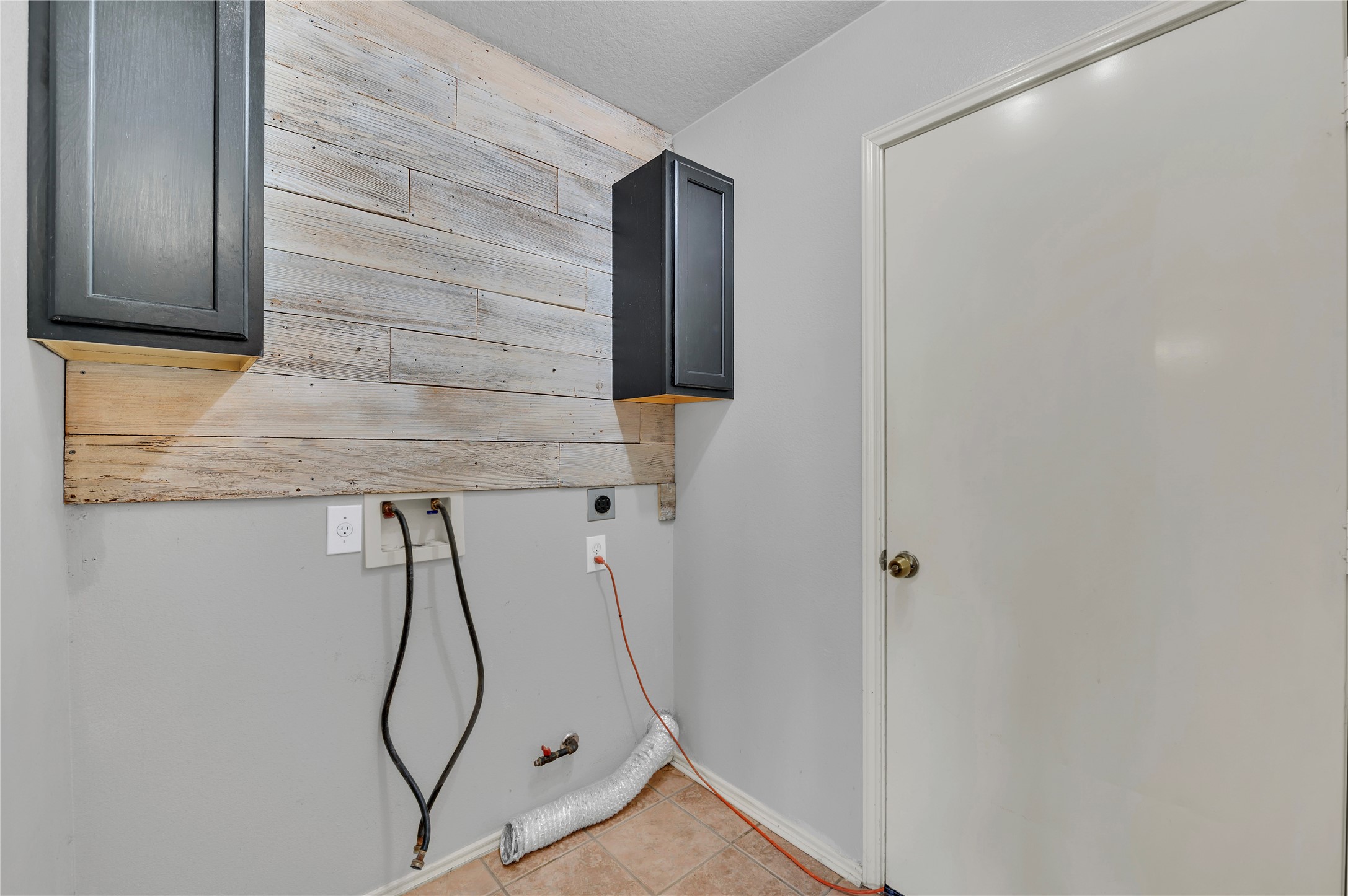 Custom cabinets in laundry room leading to garage