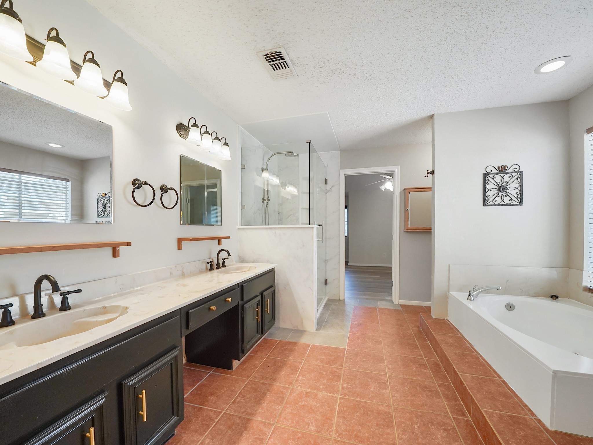 Owners bathroom. This space comes along with double sinks and an upgraded shower.
