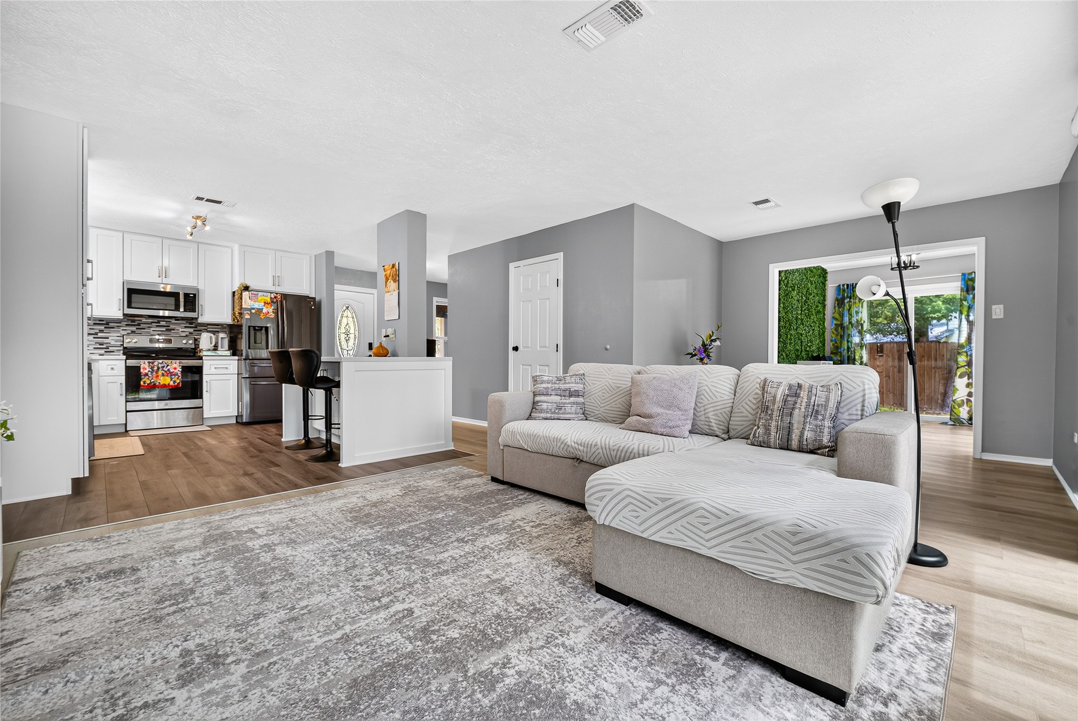 View of living room, kitchen and extra room (study or sun room)