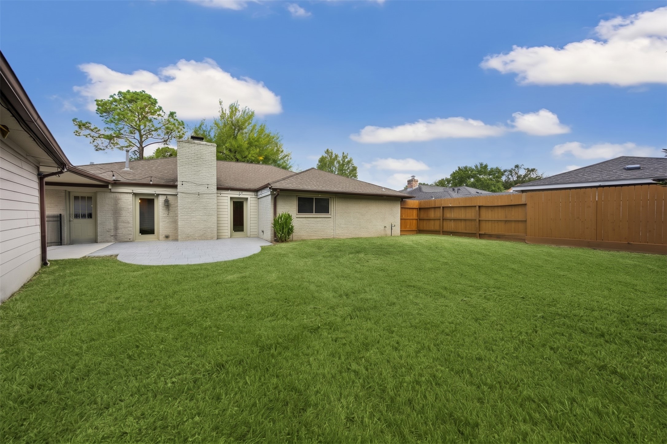 The expansive backyard provides endless green space and an array of possibilities for you to create your own personal outdoor oasis.