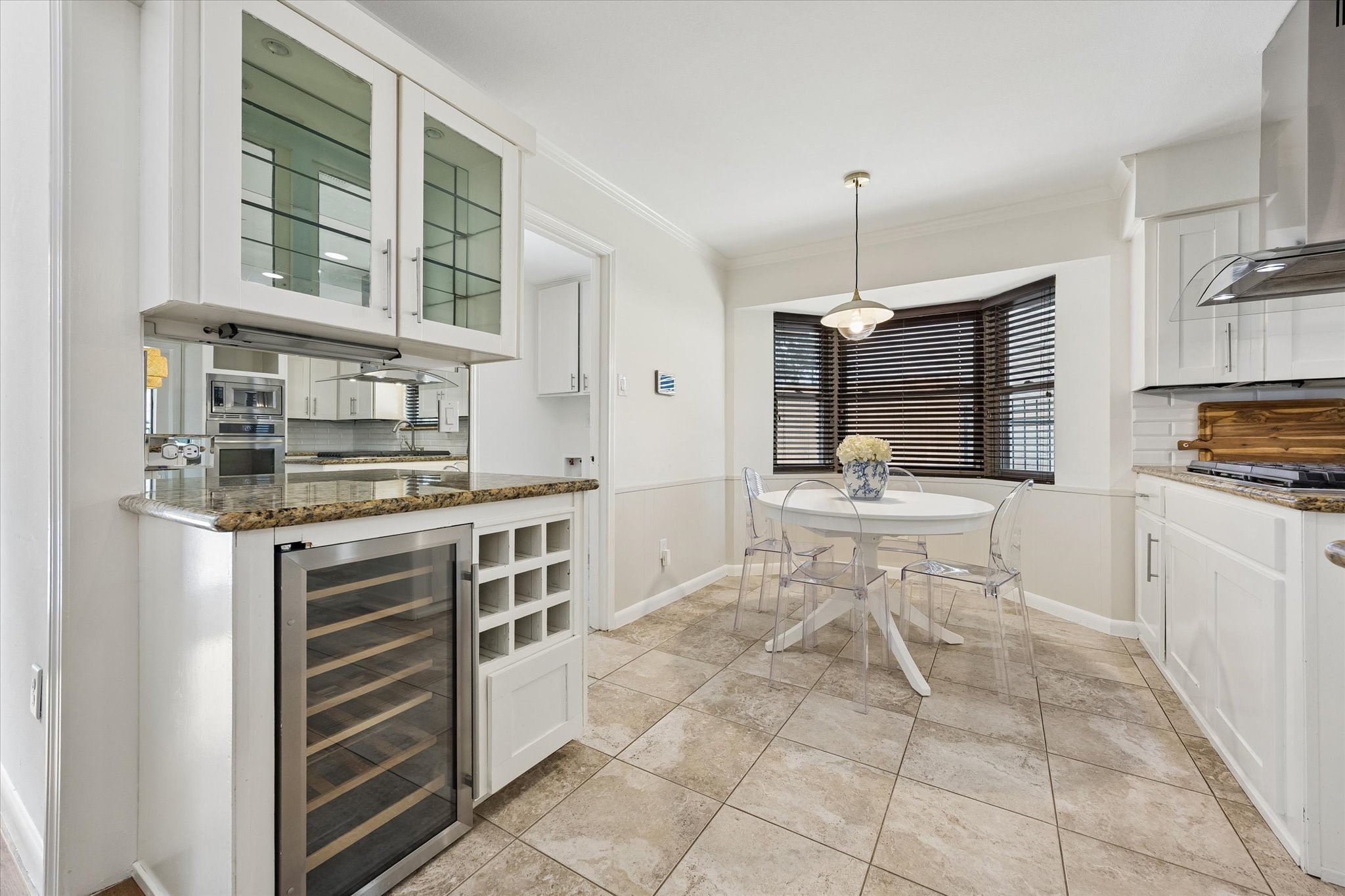 Tucked just off the kitchen, the charming breakfast room features a built-in dry bar complete with a wine fridge and glass-front cabinetryan ideal spot for organizing your glassware and favorite pieces.