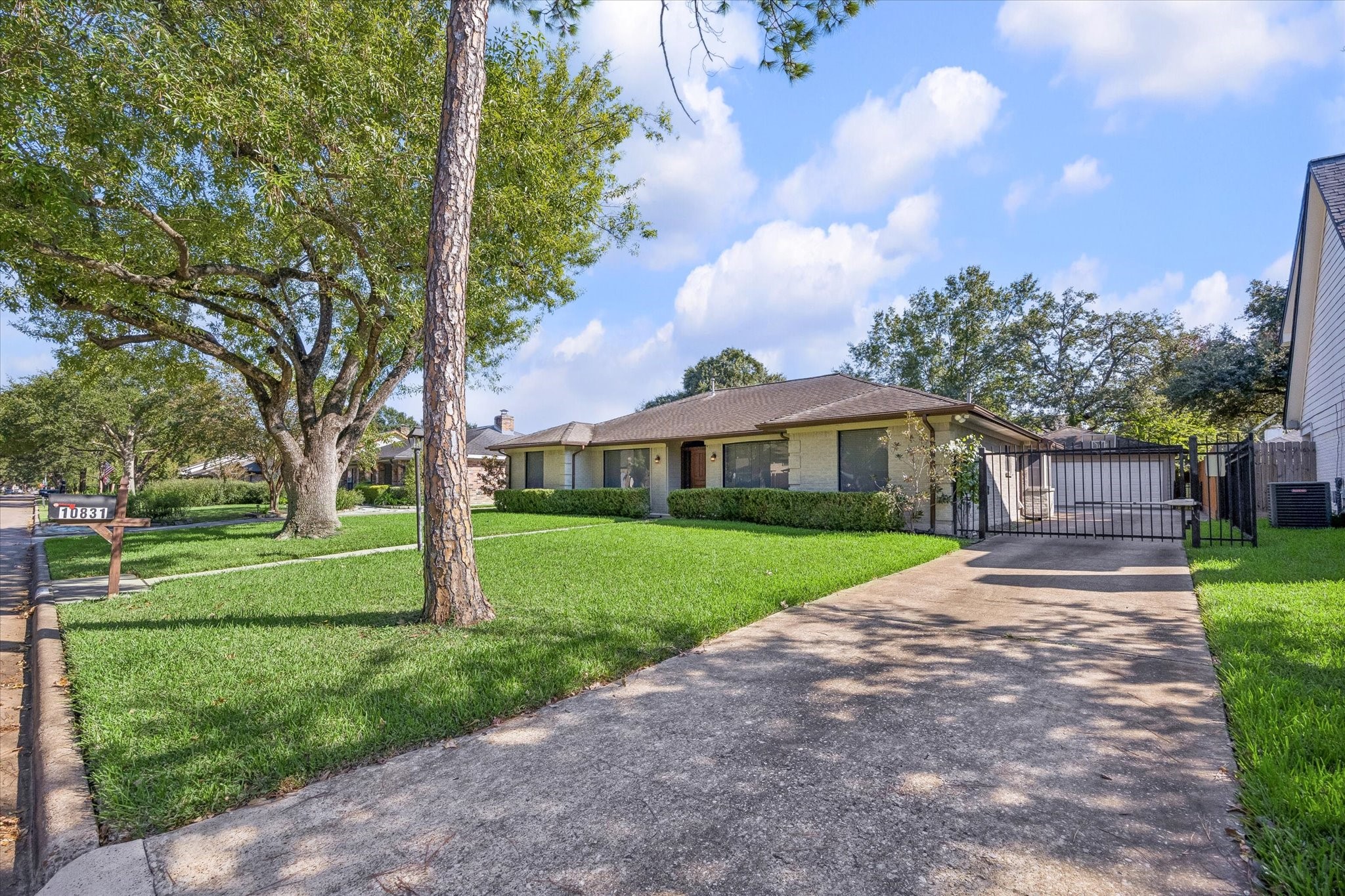 Striking curb appeal is highlighted by a manicured lawn and mature trees. The gated driveway offers privacy and peace of mind. This is an incredible opportunity you do not want to miss!