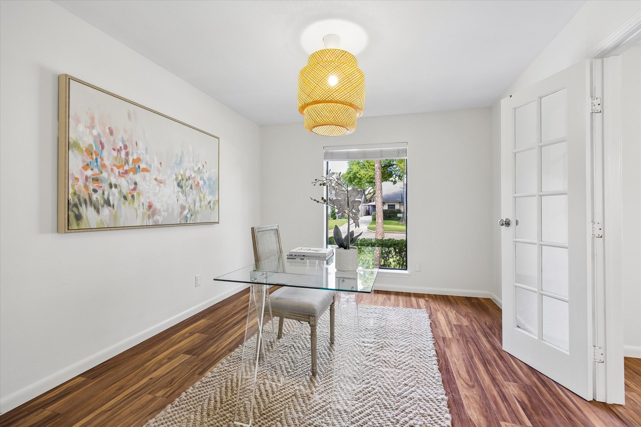 An alternative view of the office, highlighted by French doors and a charming chandelier.
