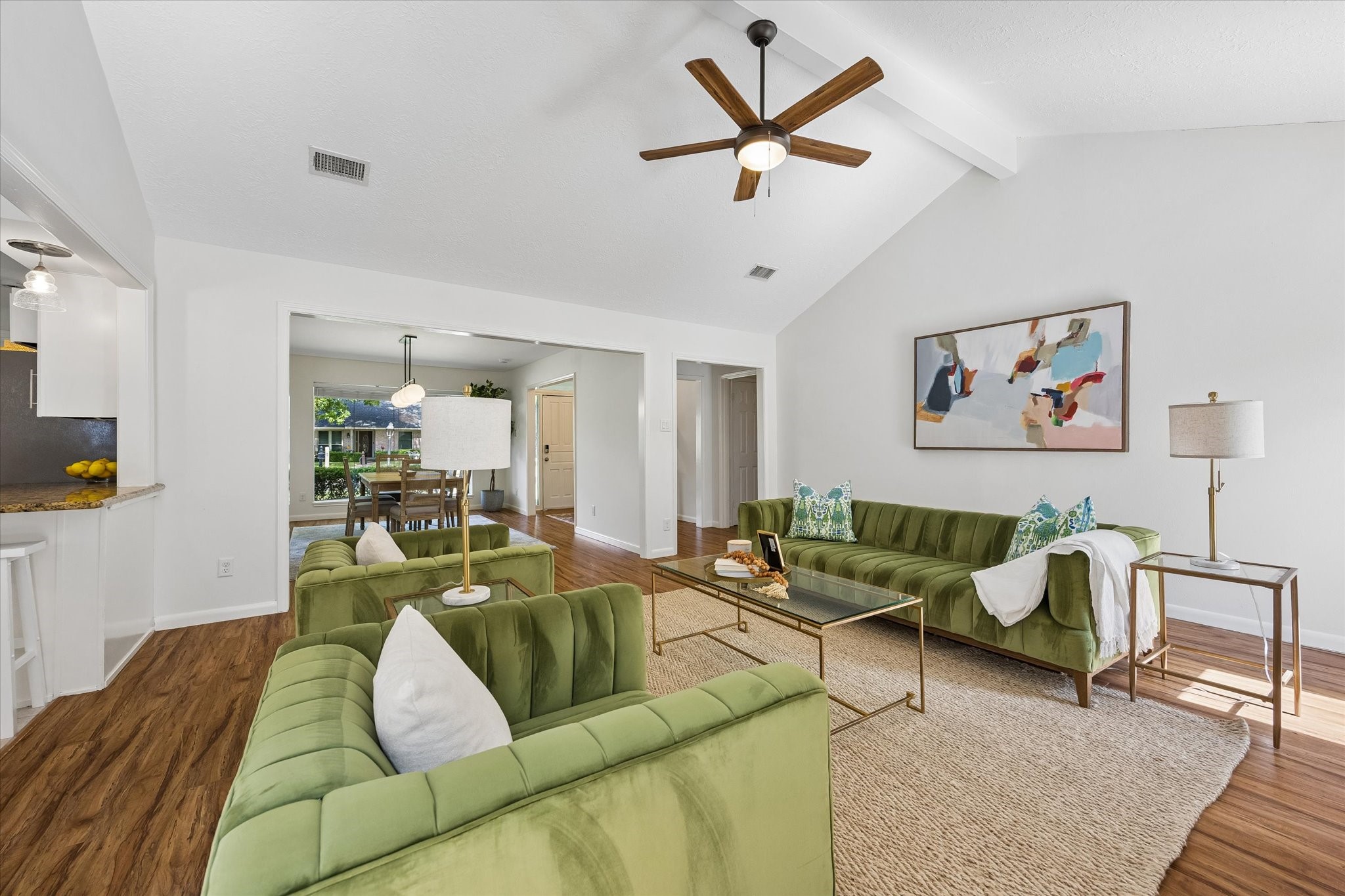 The expansive living area flows seamlessly toward the formal dining room and entry.