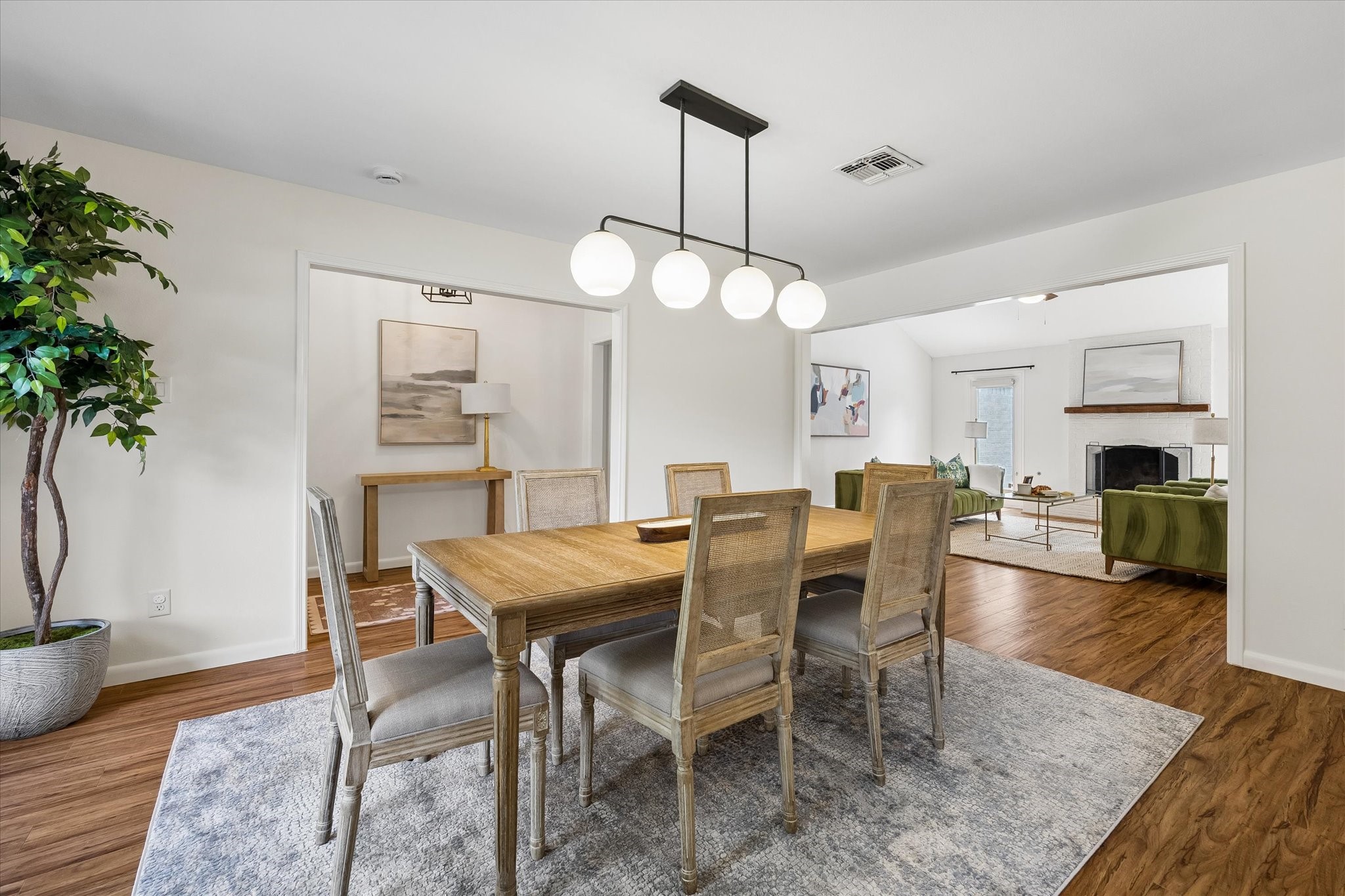 View of the formal dining room looking toward the entry and main living space. Note the abundant natural light that flows throughout.