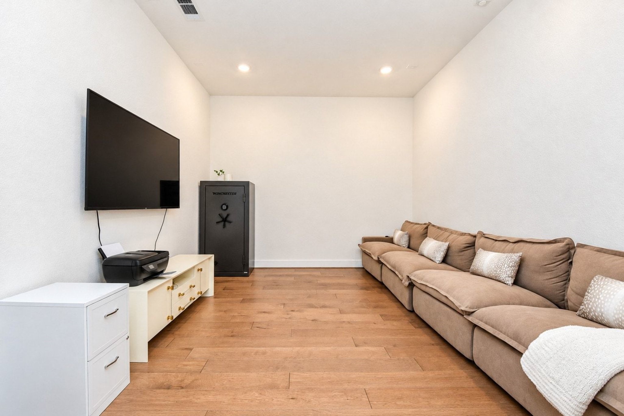 Cozy media room with hardwood flooring, perfect for relaxing and entertainment.