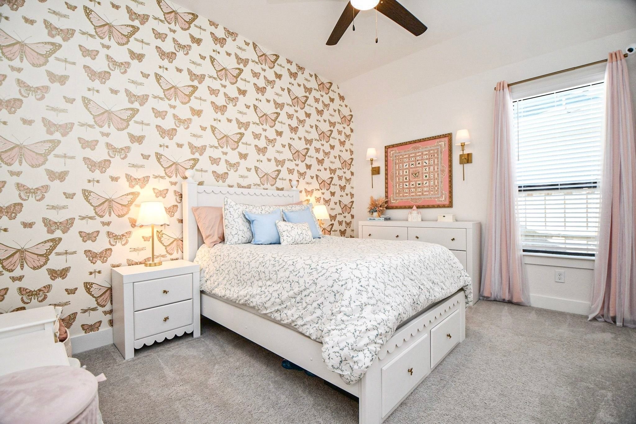Charming bedroom adorned with elegant butterfly wallpaper, featuring a cozy bed with soft pastel accents, ample natural light, and tasteful decor.