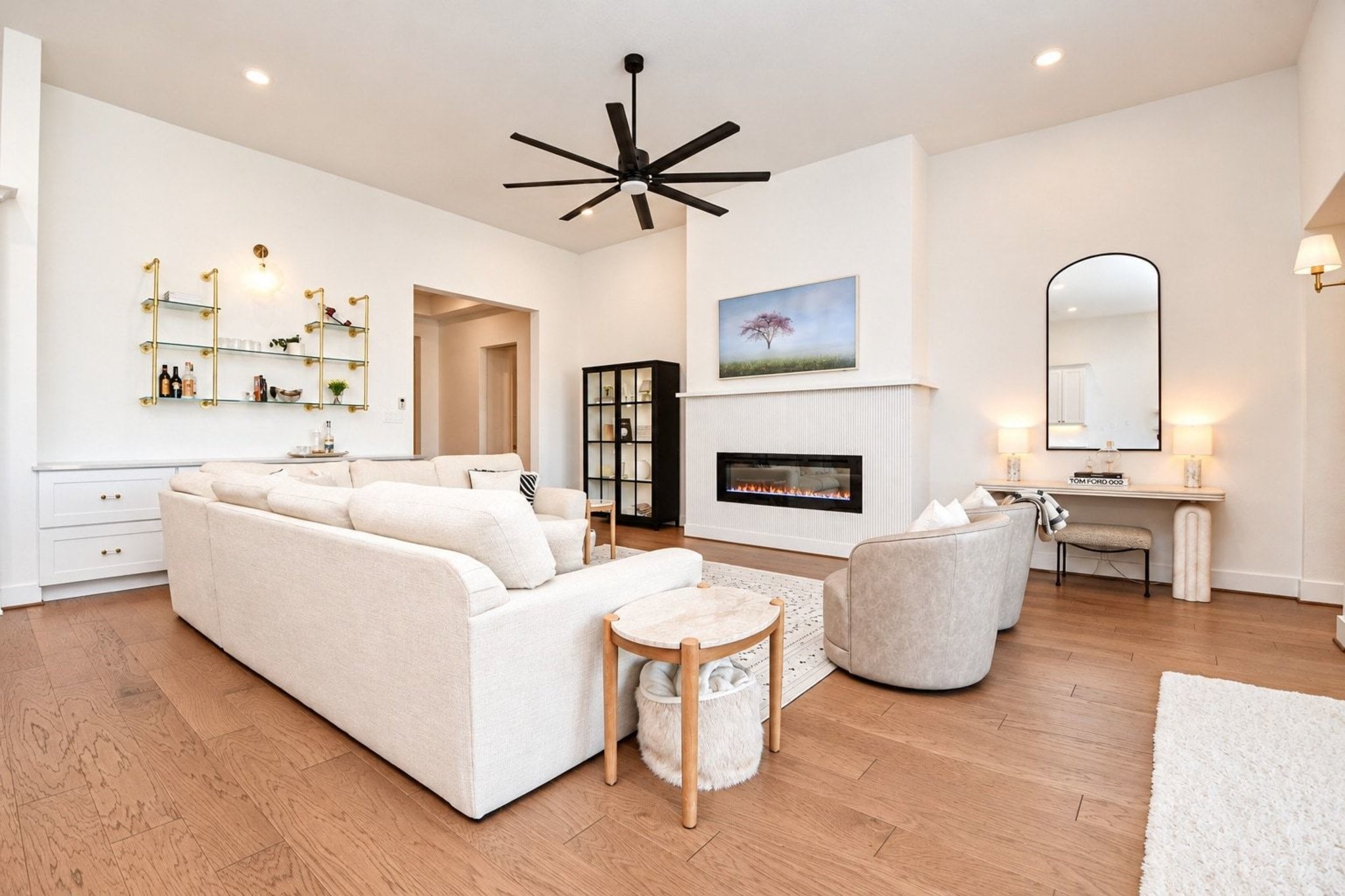 Elegant living room featuring a sleek modern fireplace with gorgeous fluted tile.  The fireplace is electric and be used year round.