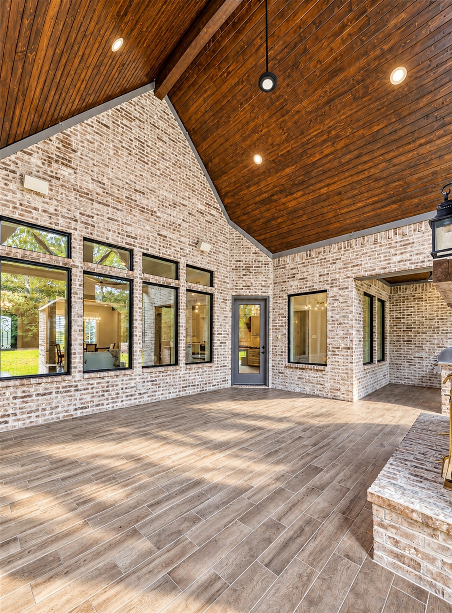 Covered patio with wood slat vaulted ceiling