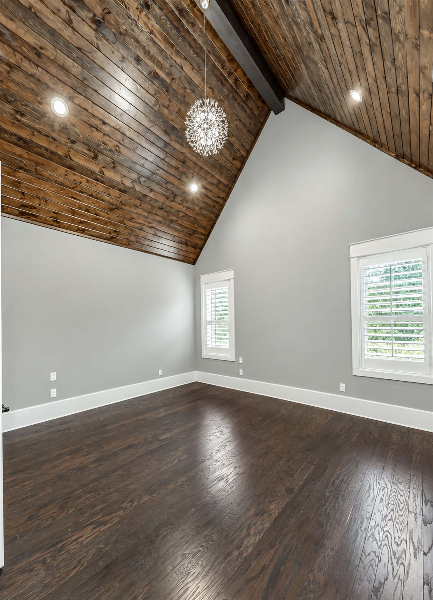 Primary bedroom with wood slat vaulted ceiling