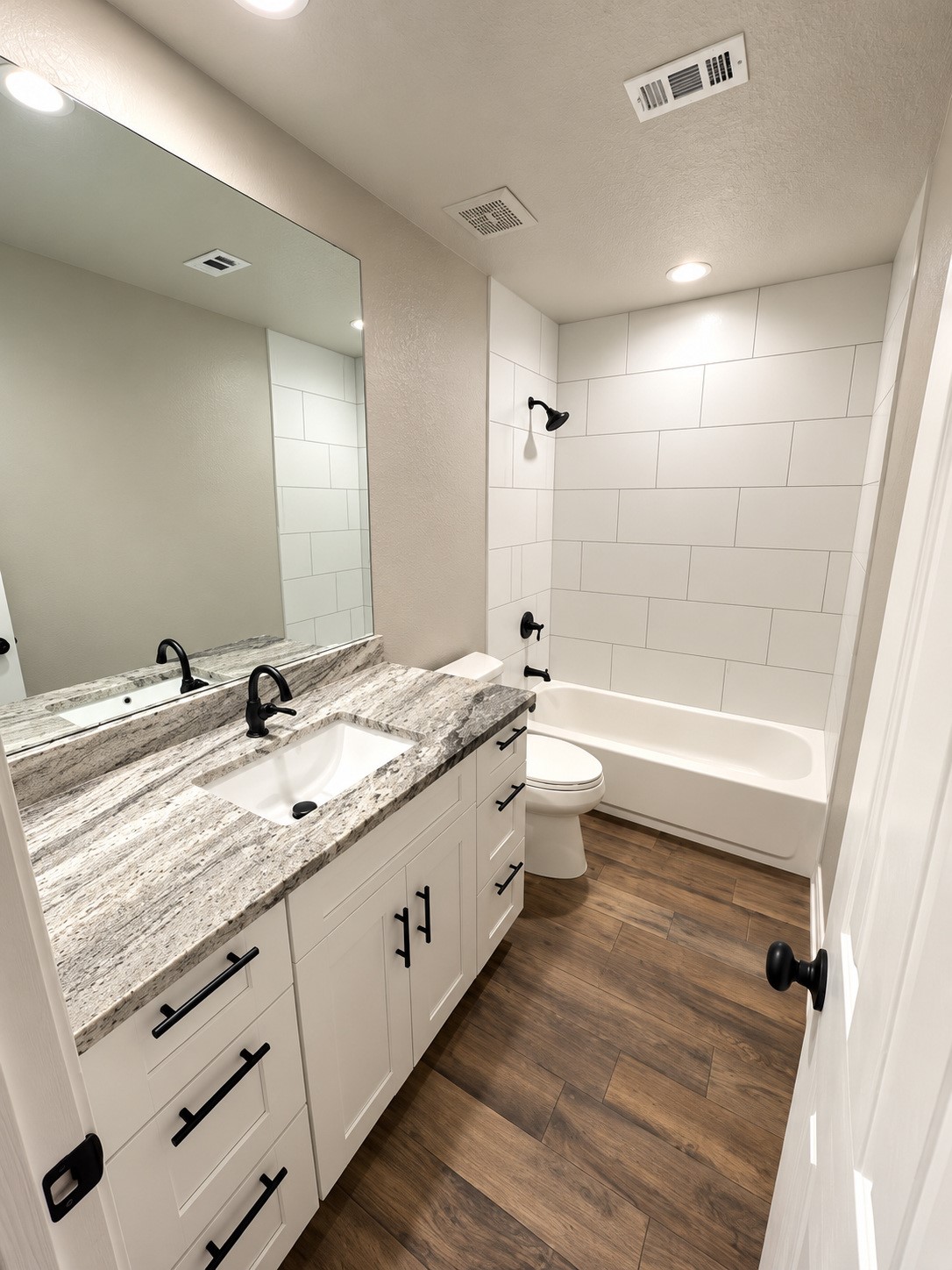 Beautifully updated upstairs bathroom featuring a single-sink vanity, modern fixtures, and stylish finishes.