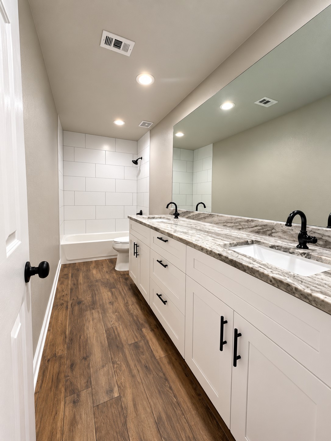 Beautifully updated upstairs bathroom featuring a single-sink vanity, modern fixtures, and stylish finishes.