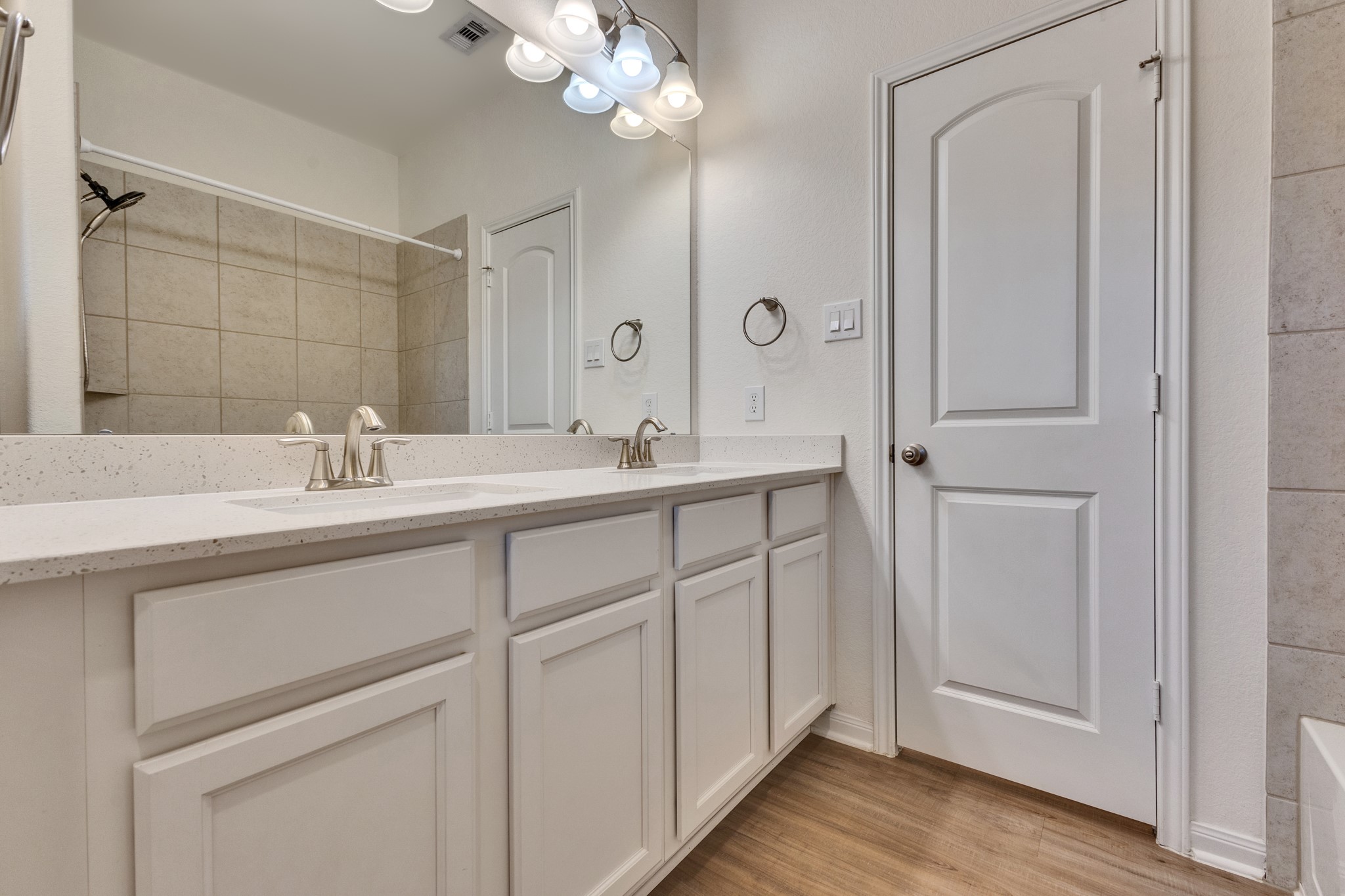 Hall Bath features dual sinks, shower/tub combo