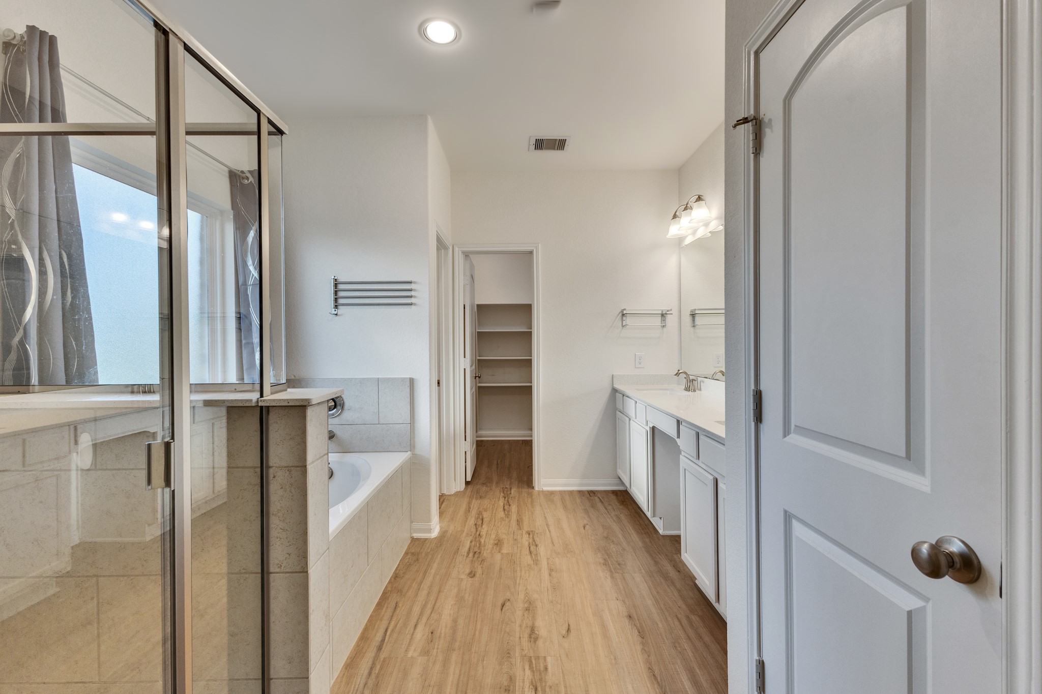 Primary Bath. Dual sinks, separate tub and walk in shower. Linen closet