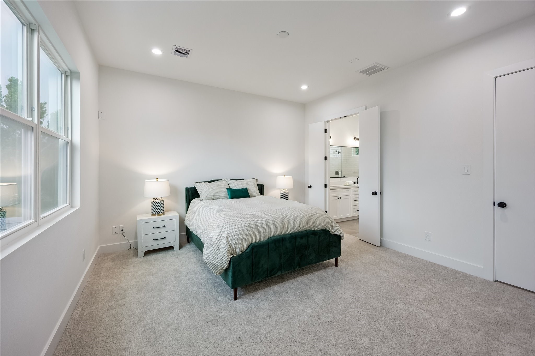The expansive primary suite is a peaceful retreat, offering abundant space for a king-size bed and creating a relaxing escape at the end of the day.