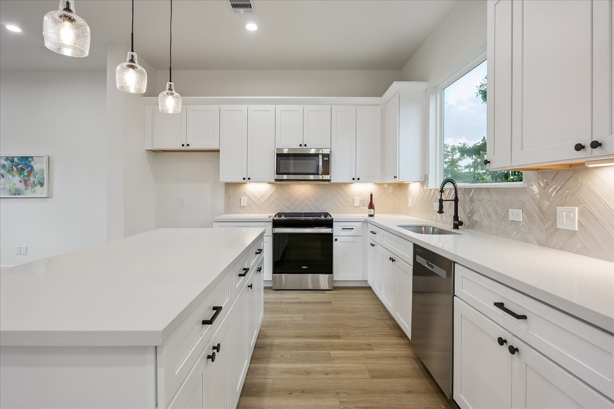 Soft-close cabinetry and drawers provide exceptional storage, while under-cabinet lighting adds both warmth and sophistication.