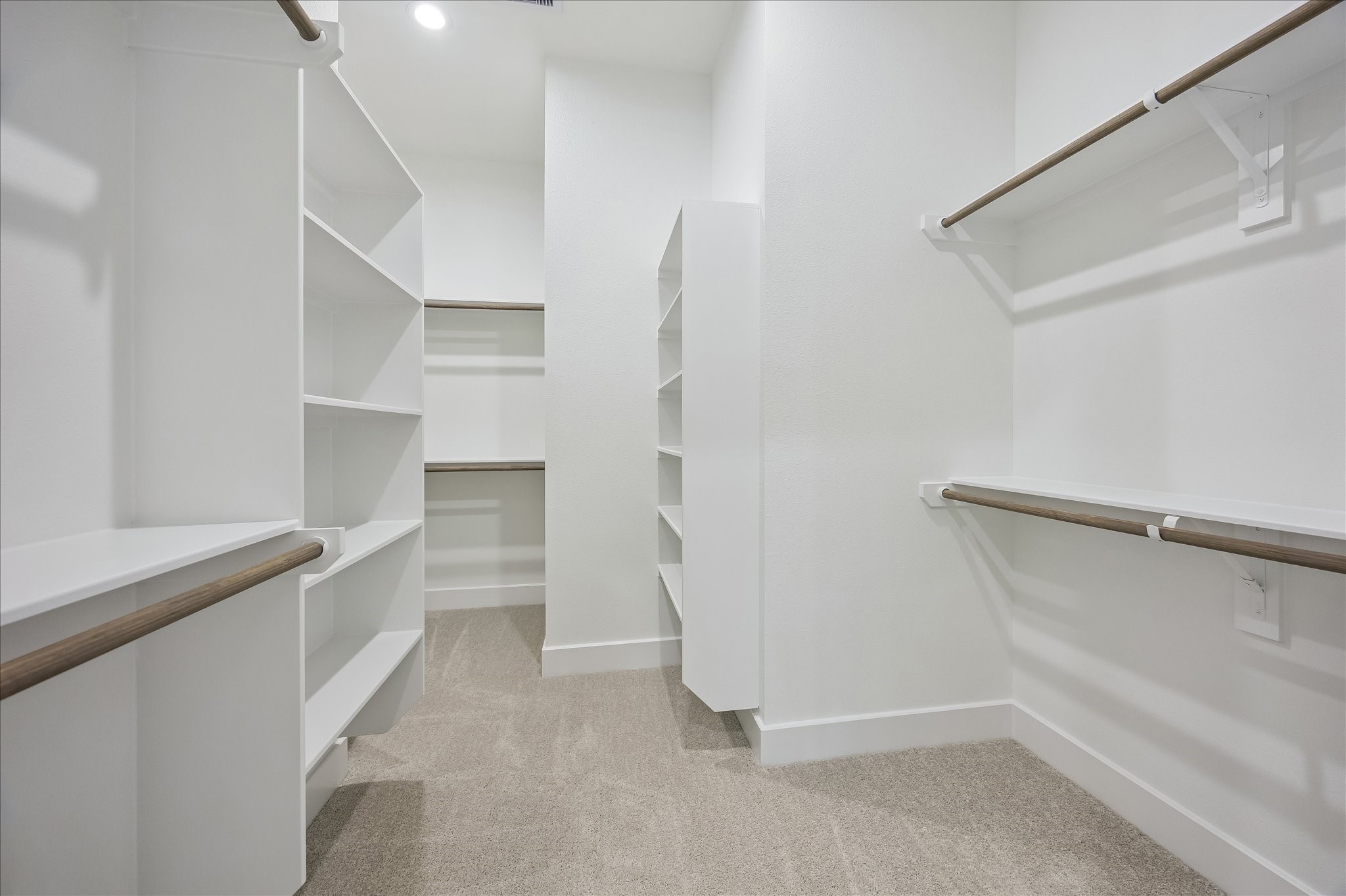 The impressive walk-in closet offers abundant hanging space and built-in shelving for effortless organization.