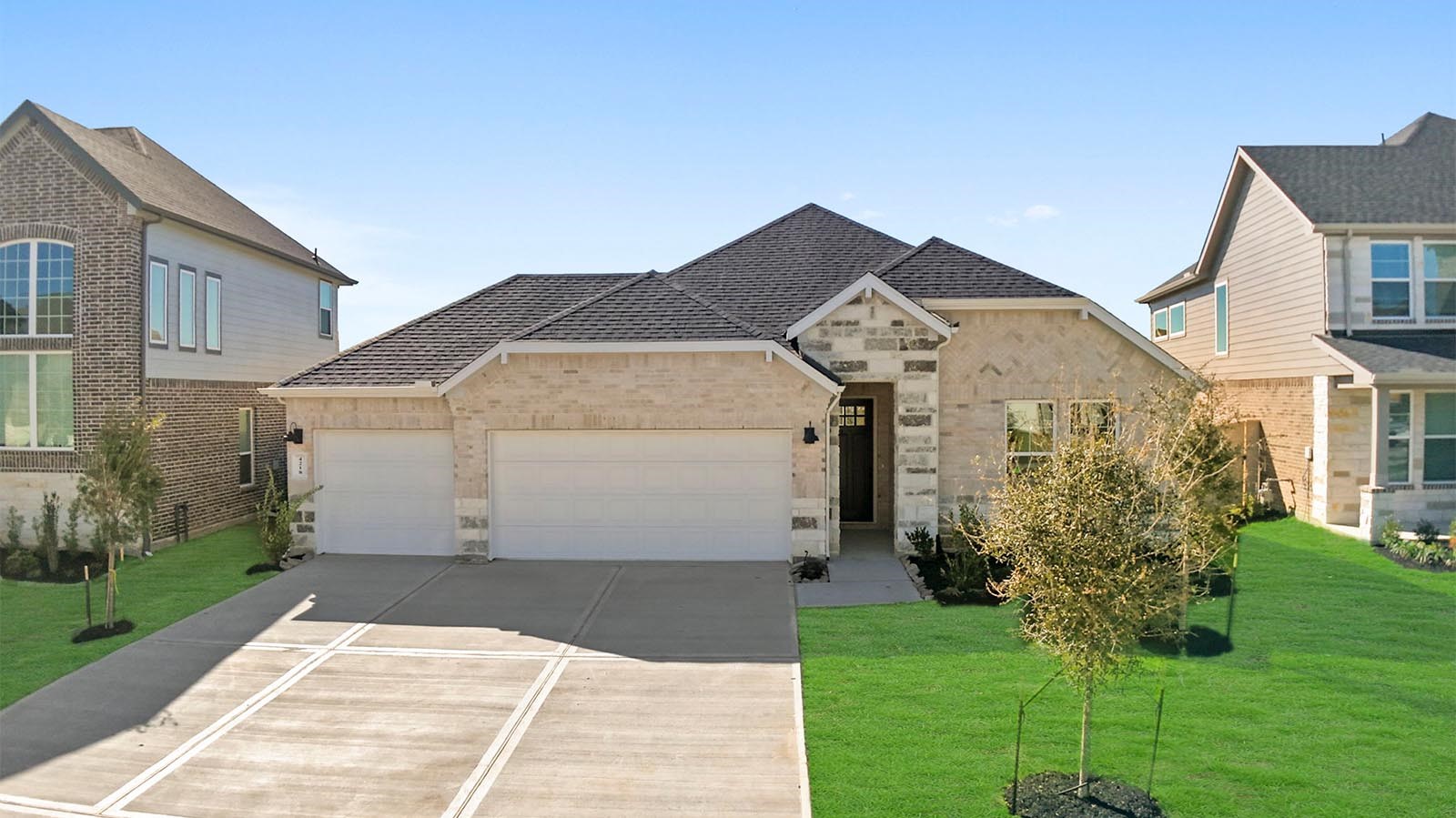 Newly built single story home with traditional architecture, a garage, and landscaped front yard. Newly built single story home with traditional architecture, a garage, and landscaped front yard.