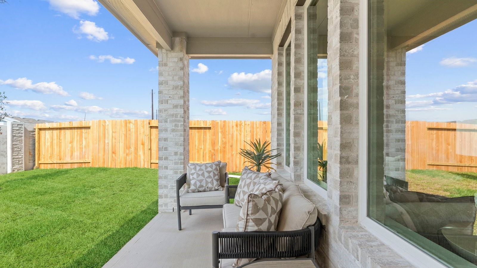 Outdoor covered patio with room for outdoor furniture to enjoy the backyard in those cooler months