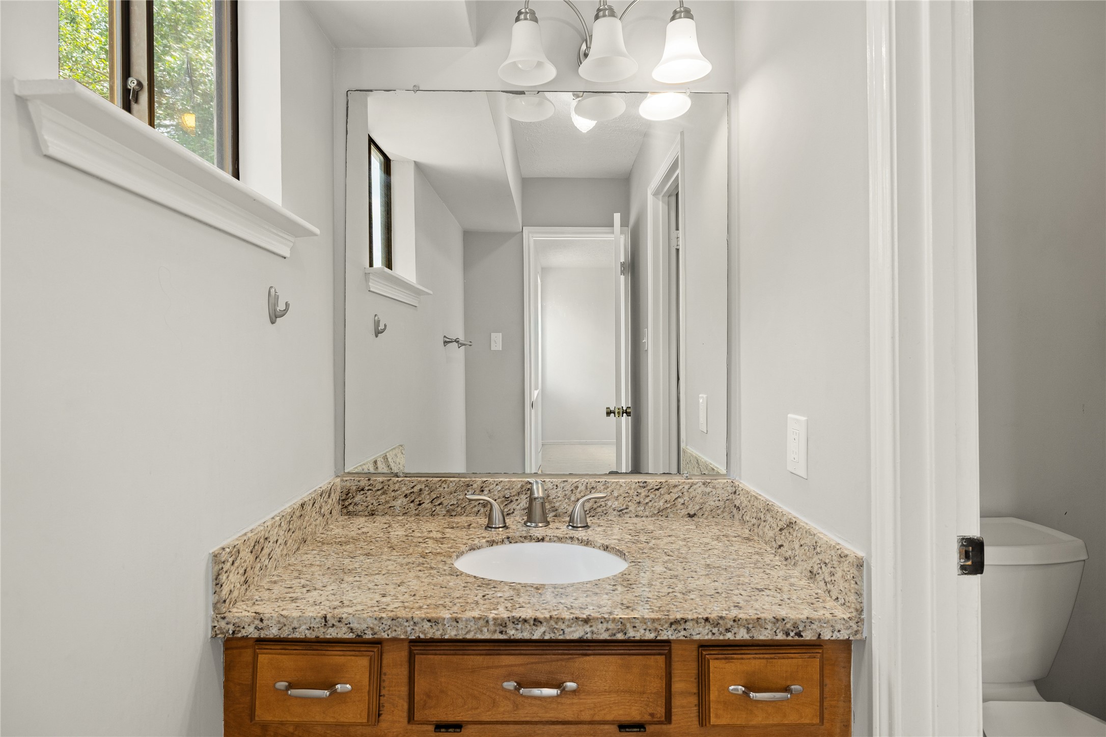 Secondary bedroom private vanity and access to shared bathroom.