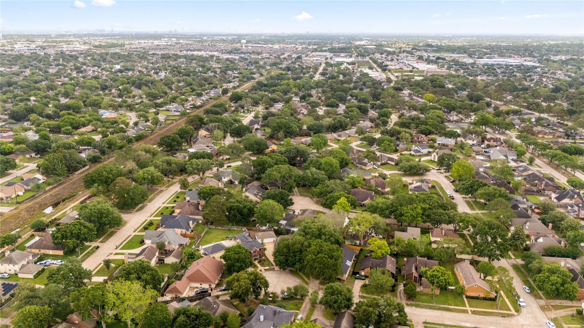 This impressive aerial perspective showcases the neighborhood's meticulous layout, featuring quiet streets, lush green spaces, and a true sense of suburban serenity. Enjoy the benefit of being part of a thriving area with easy access to local amenities and major thoroughfares, all while maintaining the peaceful atmosphere of a residential retreat.