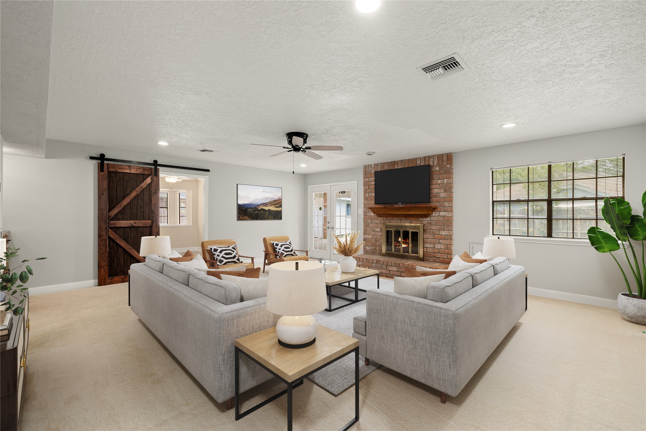 This expansive living area seamlessly transitions into the heart of the home, featuring a stylish sliding barn door that opens to the kitchen and breakfast nook. *Virtually Staged