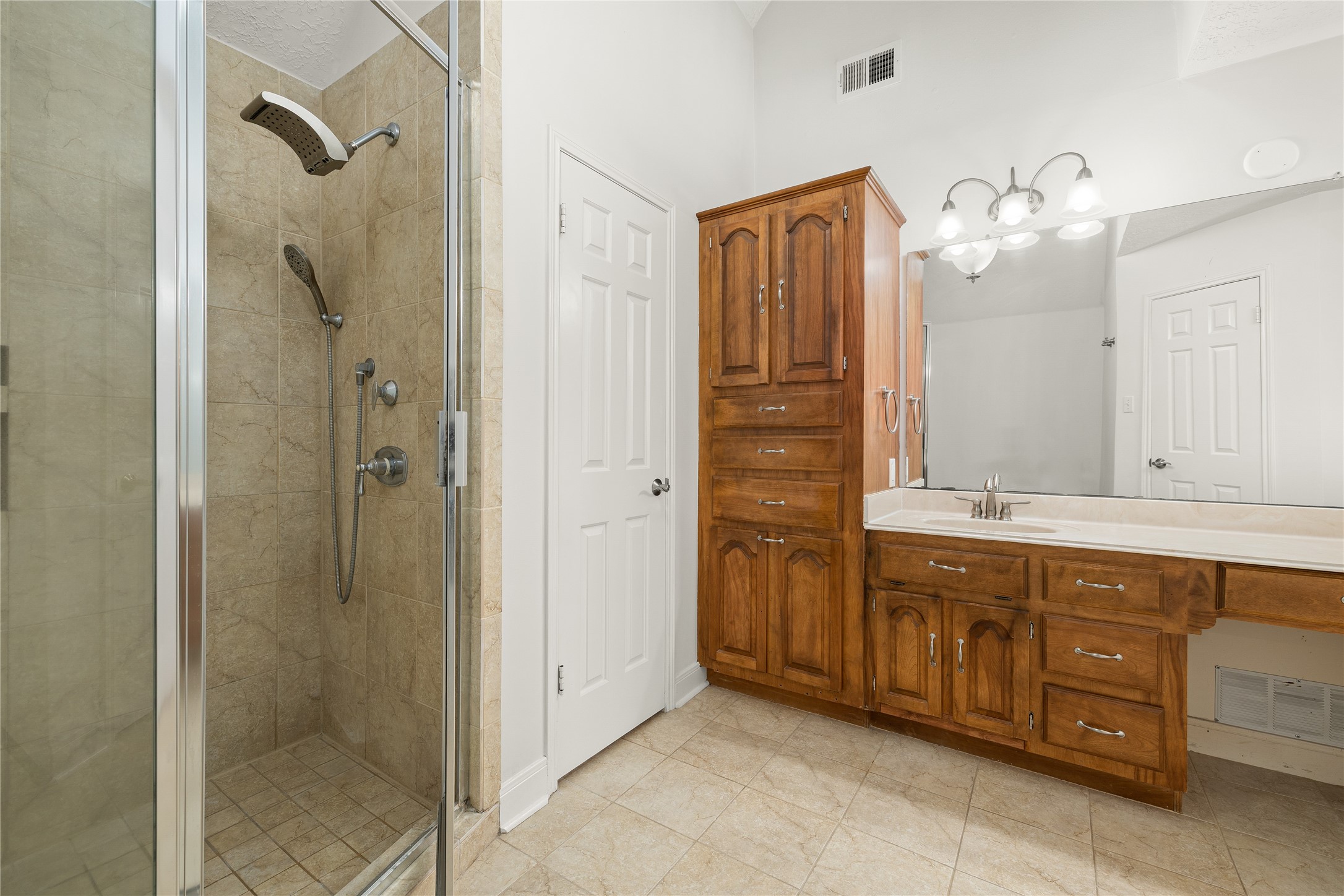 Indulge in a spa-like experience with this meticulously designed walk-in shower, a standout feature of the primary ensuite. Combining modern luxury with practical elegance, this space offers a tranquil retreat for your daily routine.