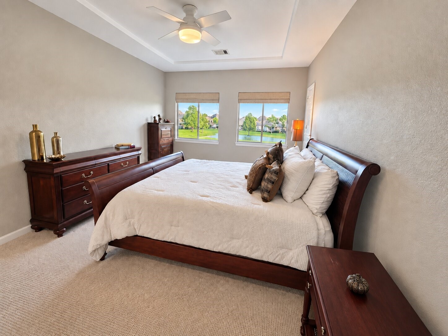Another view of the secondary bedroom highlighting the serene lake views.