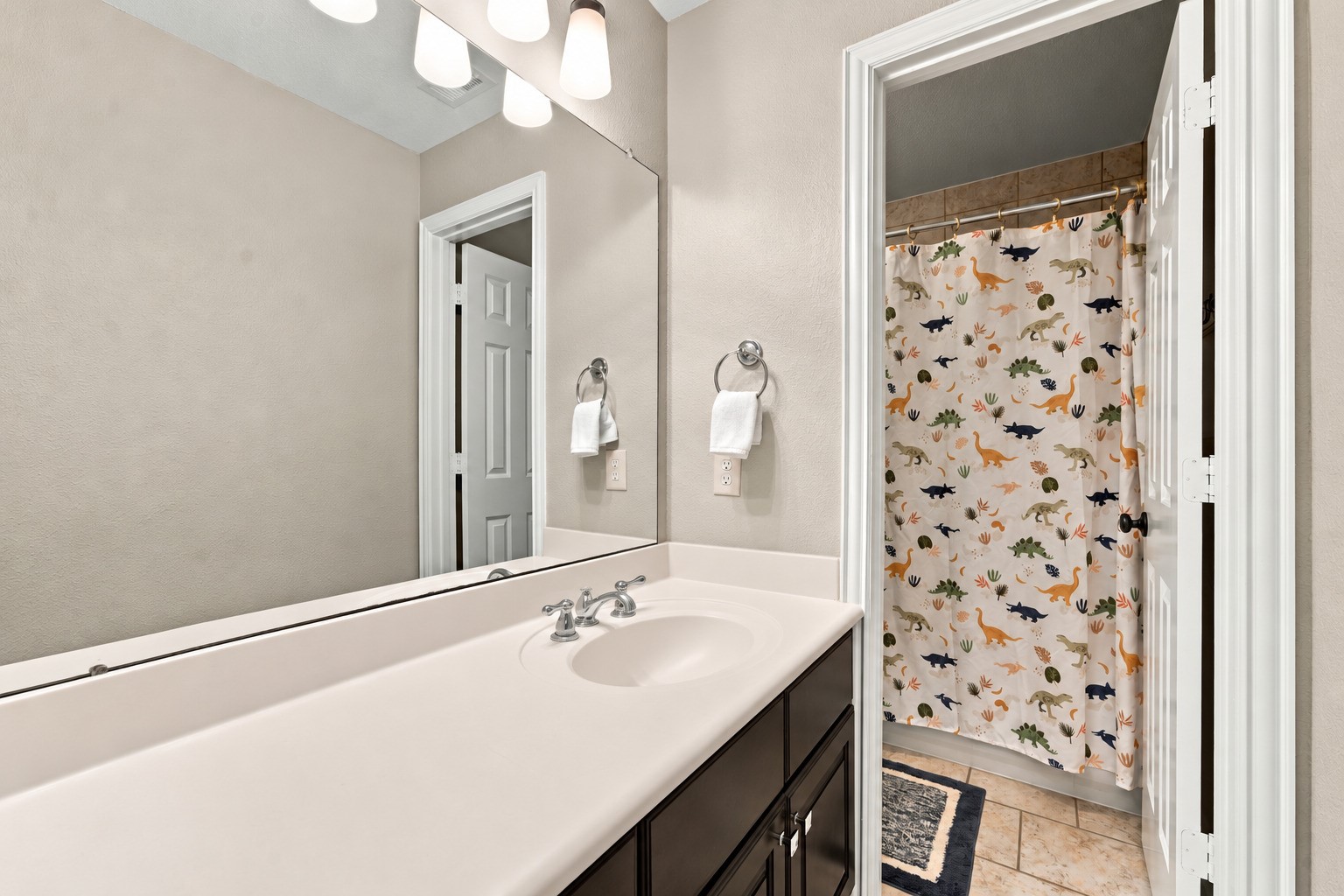 This bathroom connects to a secondary bedroom while also offering convenient access from the second-floor landing.